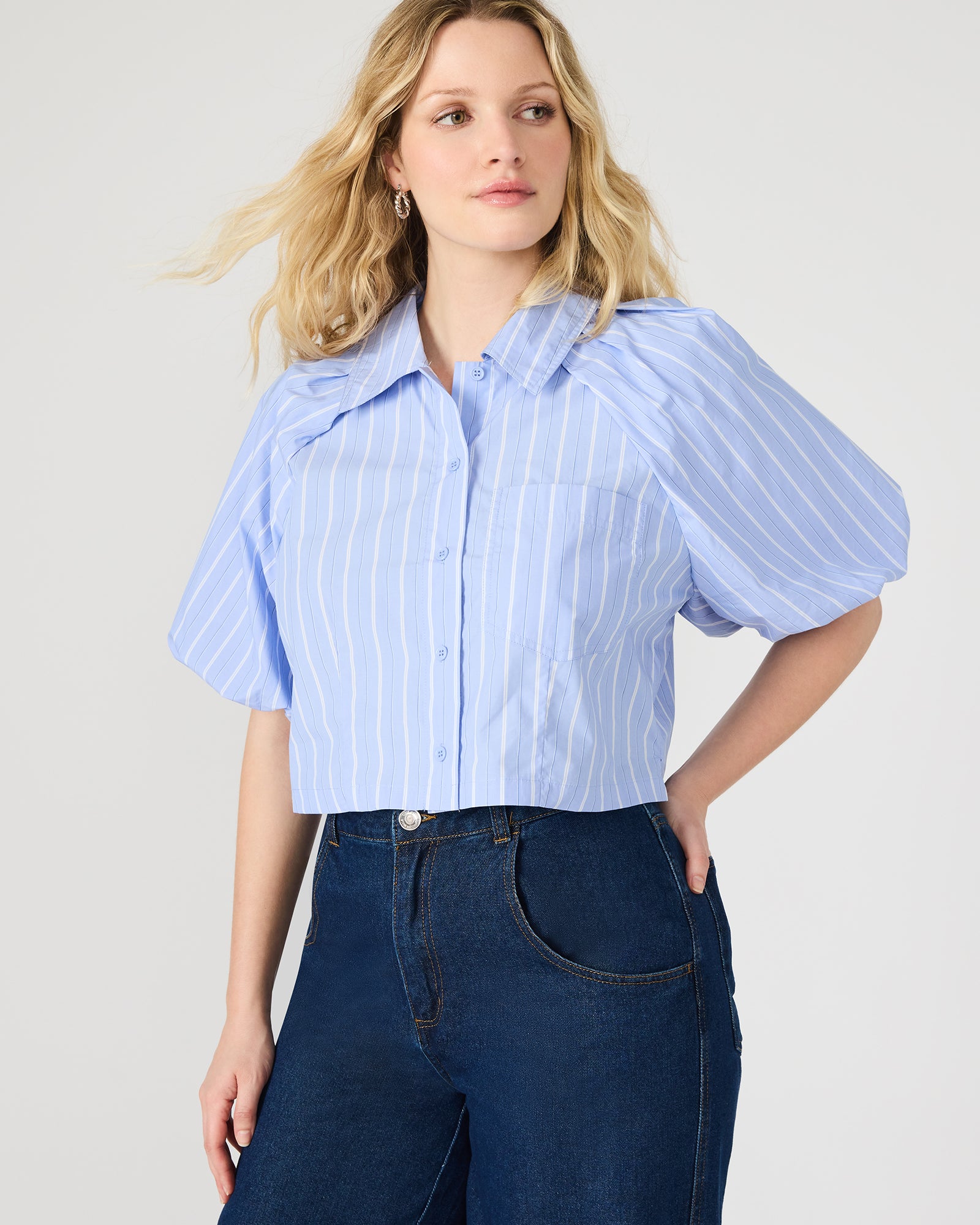 Front view of soft blue bubble sleeve crop top on model