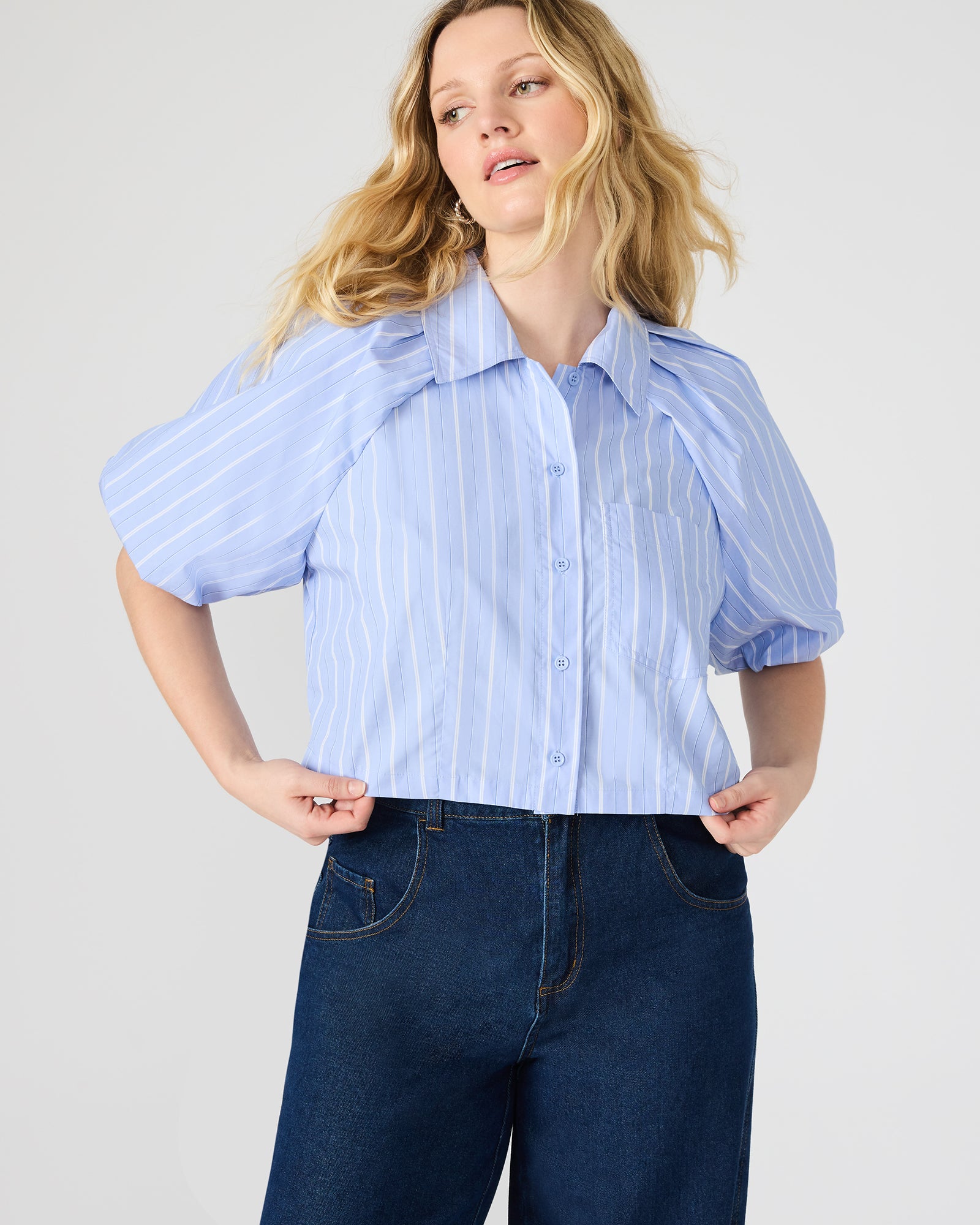 Side view of bubble sleeve top paired with stylish jeans