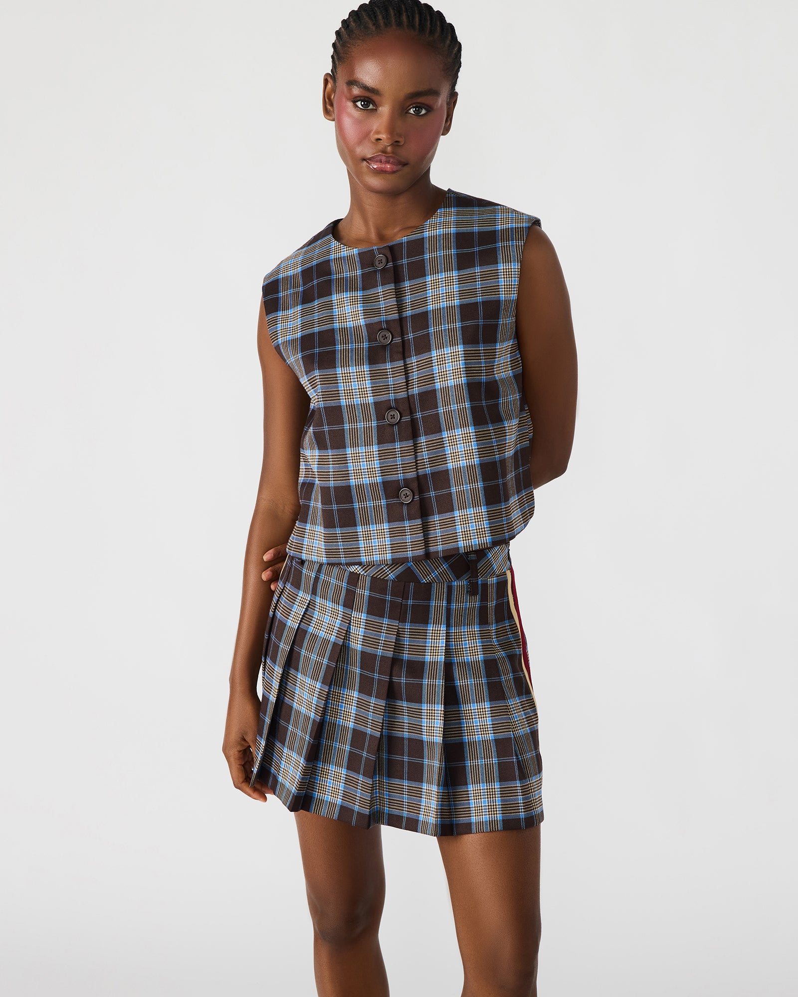 Side profile of model wearing the brown plaid blouse paired with denim — perfect for Detroit weekends
