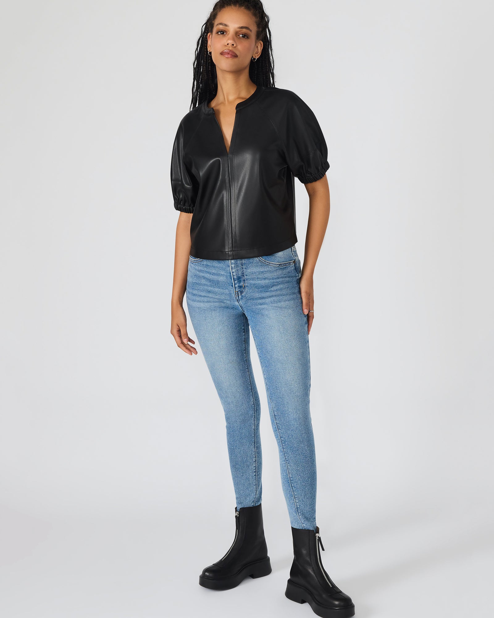 Model wearing the black crop top with puff sleeves for a night out.