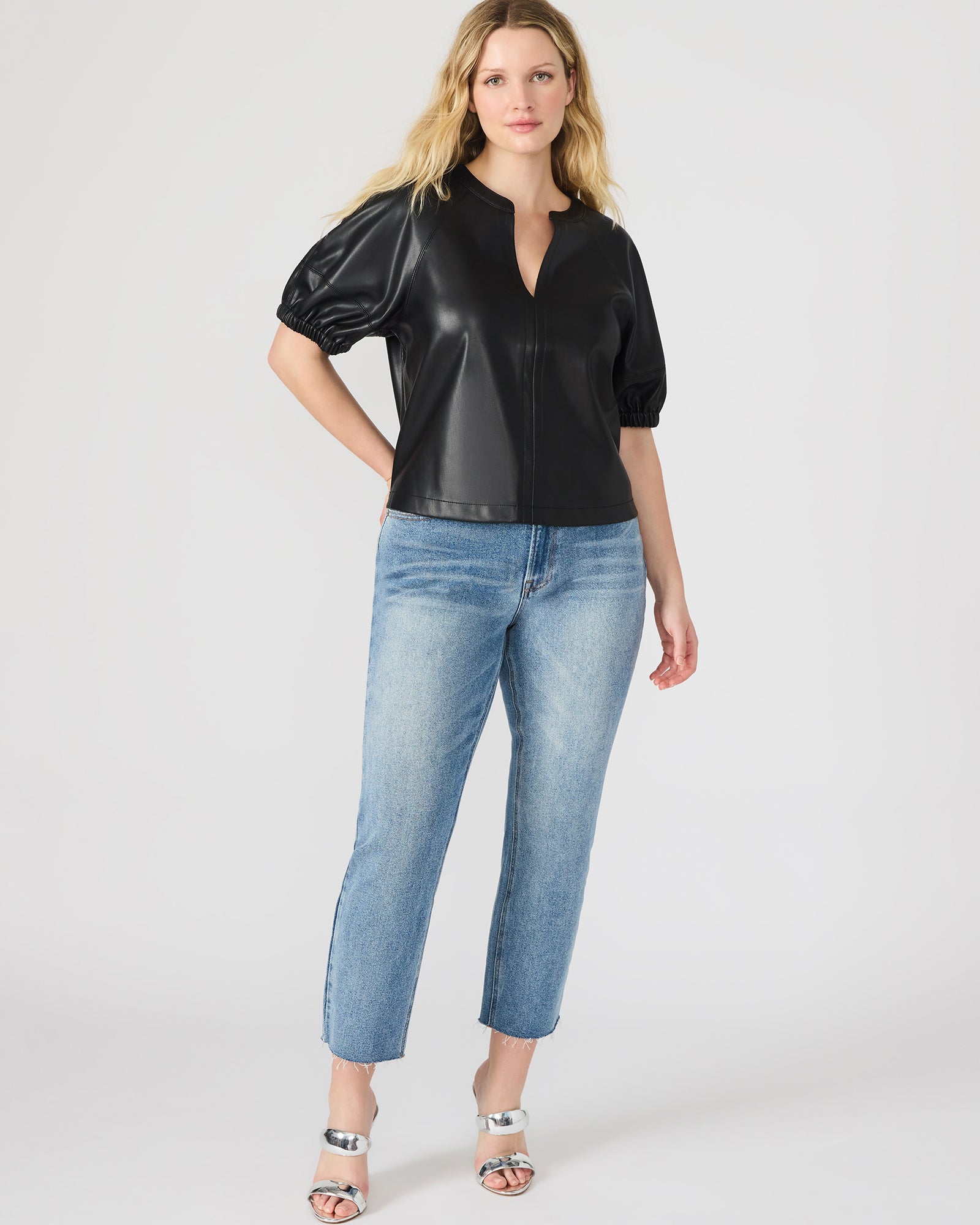 Side view showcasing the elegant silhouette of the black leather top.
