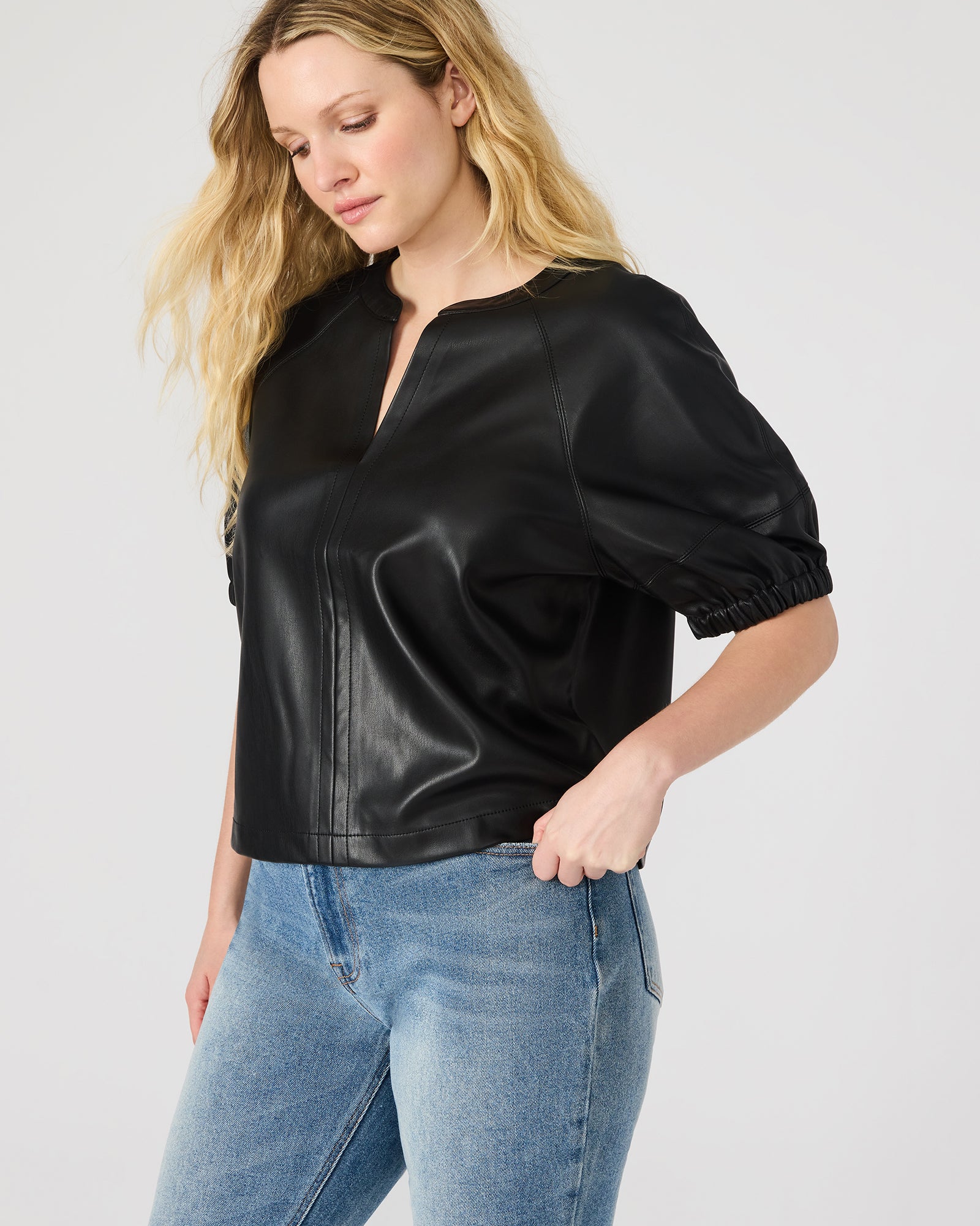 Model wearing the black crop top with puff sleeves for a night out.