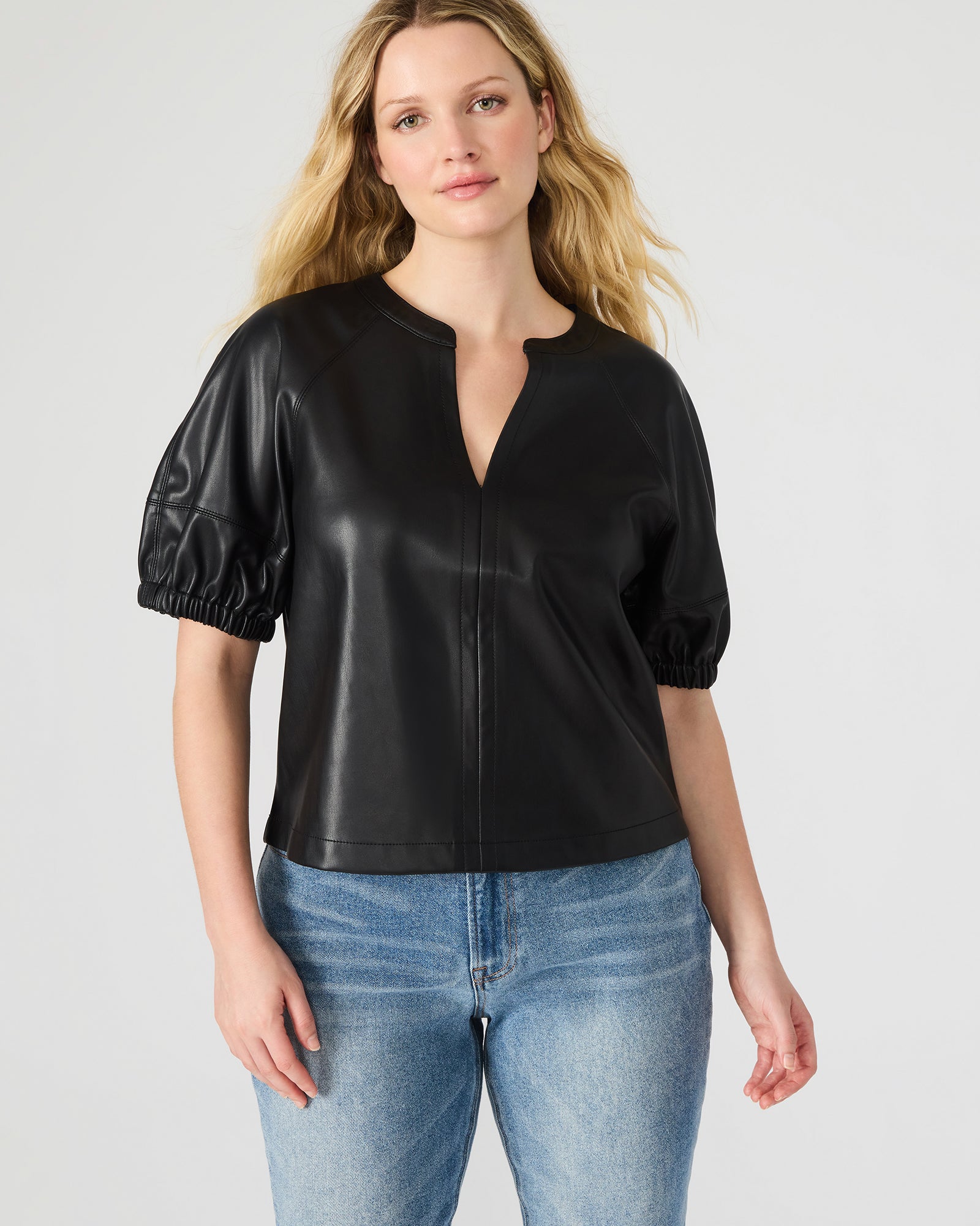 Front view of Roxanne black leather crop top featuring puff sleeves.