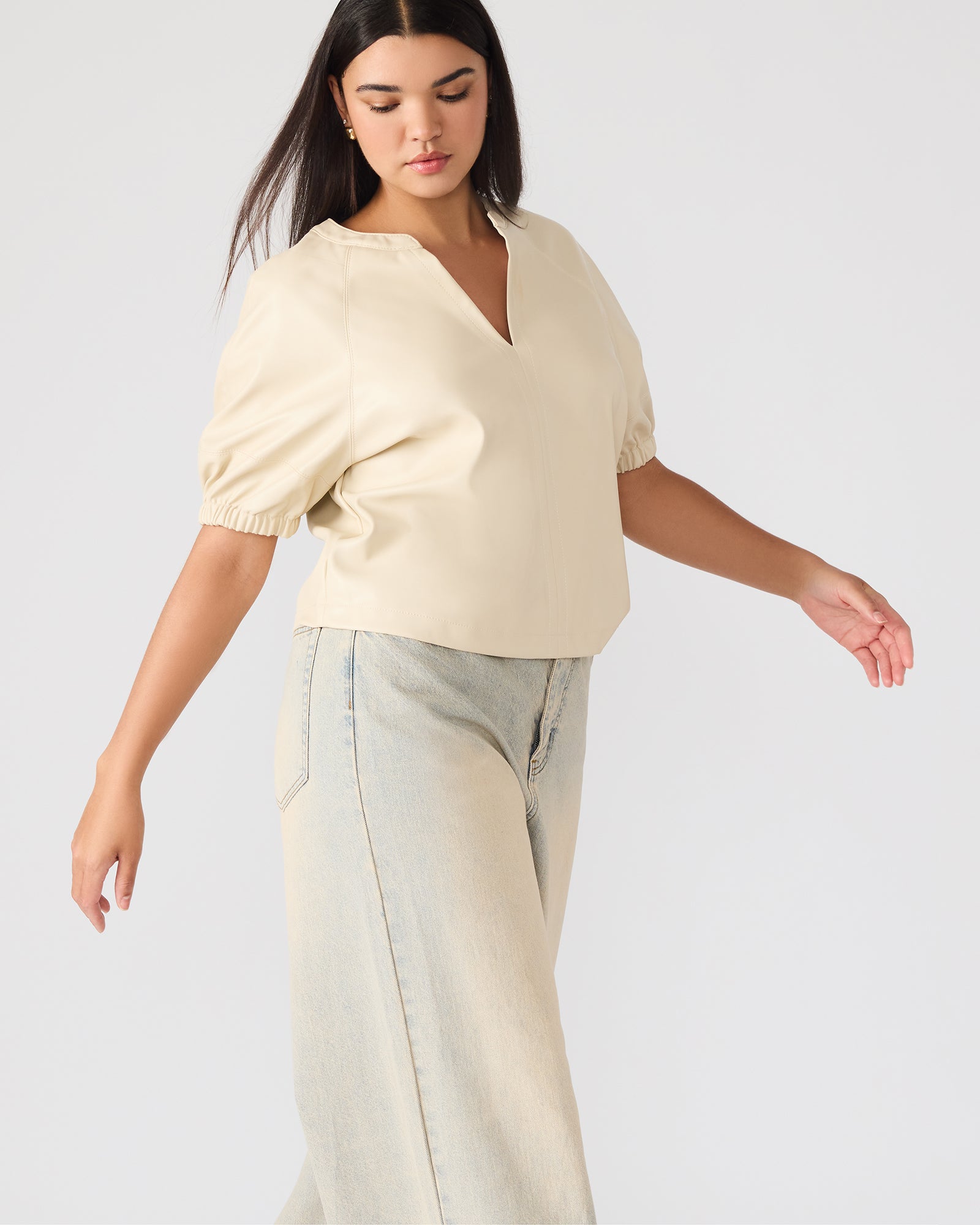 Model styling Roxanne top with high-waisted trousers for evening look