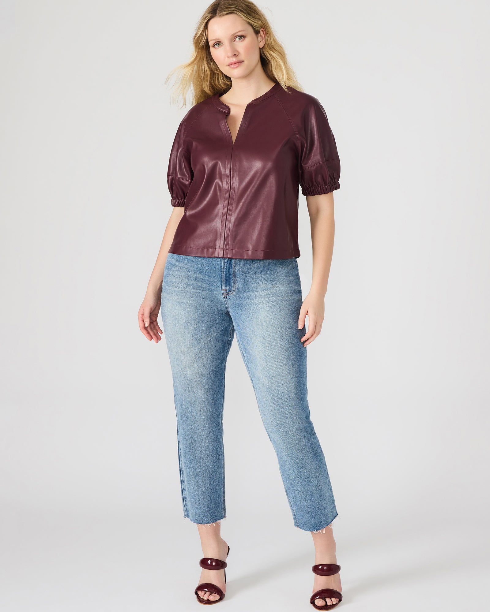 Front view of the black puff sleeve top highlighting the puff sleeve detail and sleek silhouette