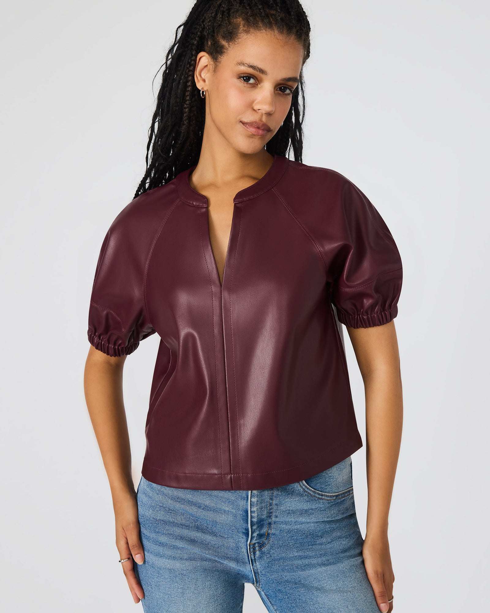 Front view of the black puff sleeve top highlighting the puff sleeve detail and sleek silhouette