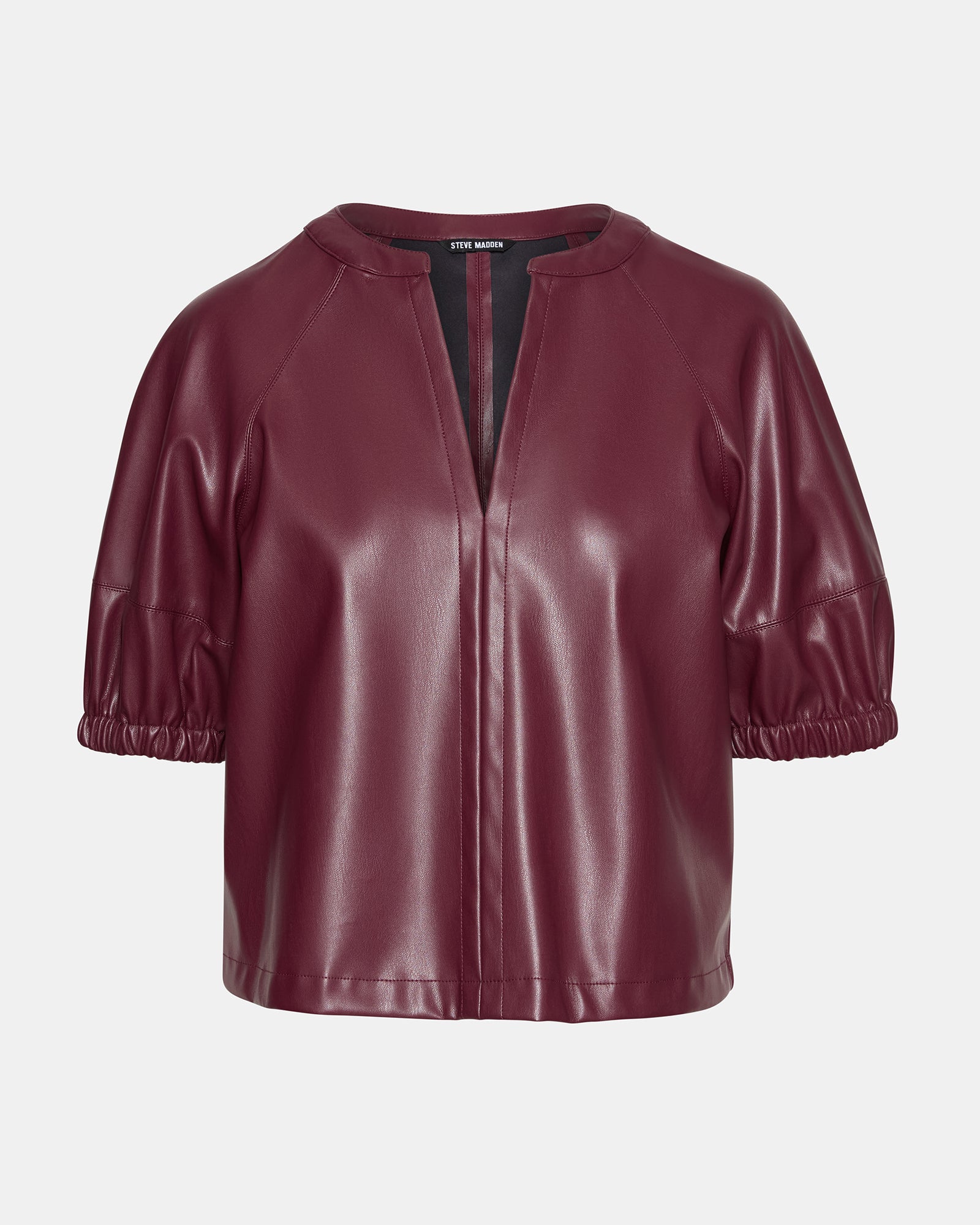 Model showcasing the faux leather puff sleeve top with off-the-shoulder style for a trendy look