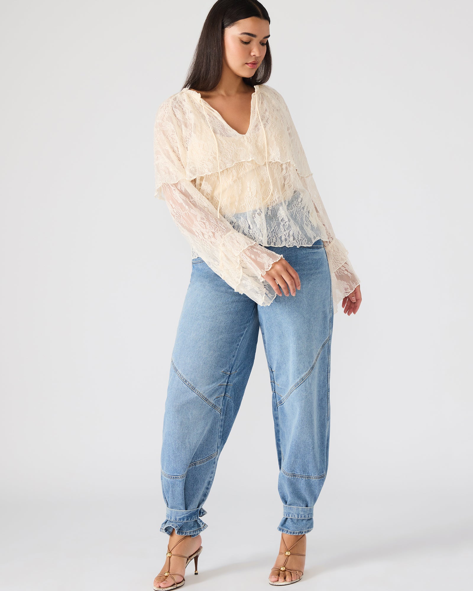 Side angle of Saylor elegant lace top, highlighting its delicate lace design.