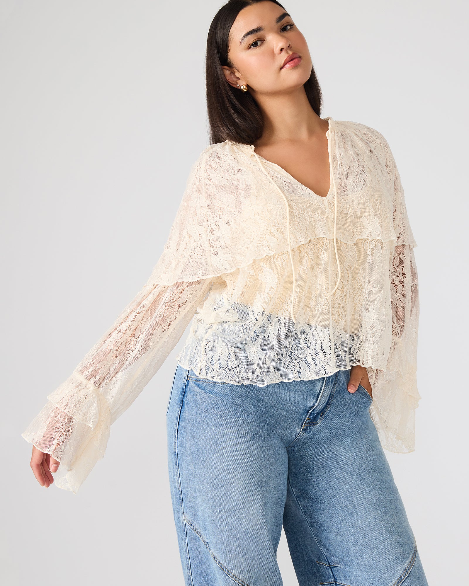 Back view of Saylor cream lace top, emphasizing the bell-flared sleeves.