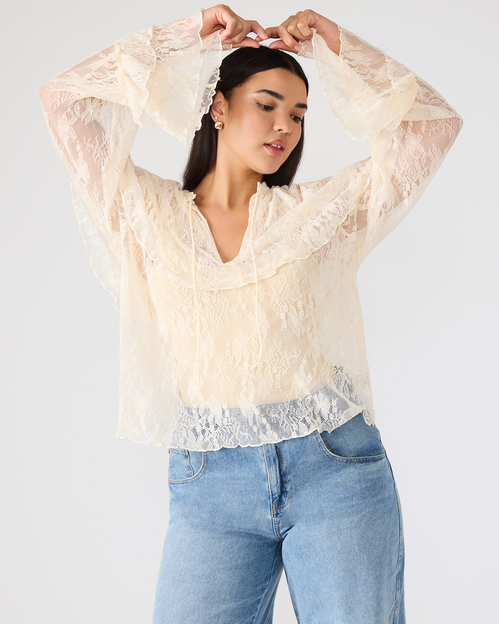 Front view of Saylor lace long sleeve top in cream, showcasing ruffle sleeves.