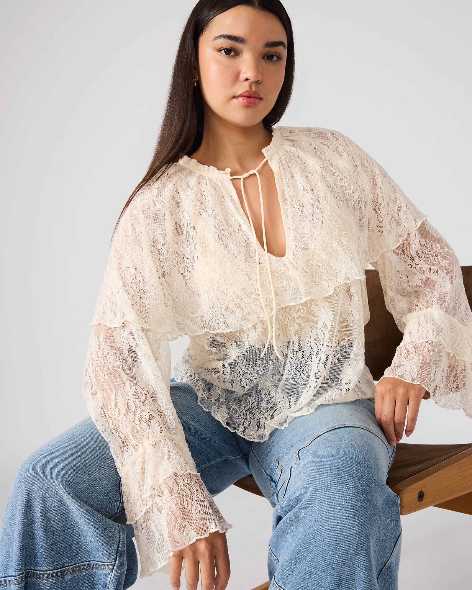 Front view of Saylor lace long sleeve top in cream, showcasing ruffle sleeves.