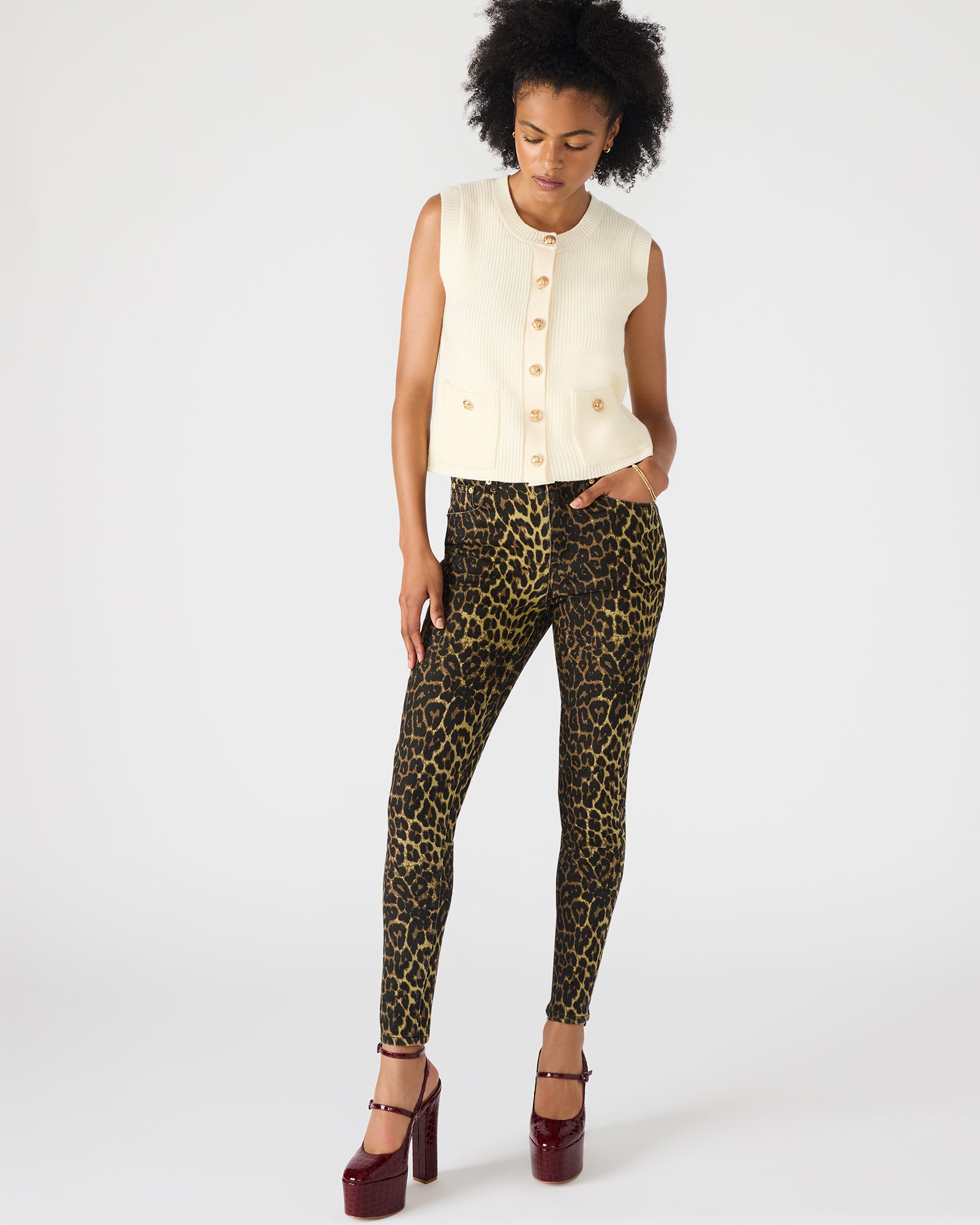 Front view of cream Aliya sweater vest styled with a crisp white shirt
