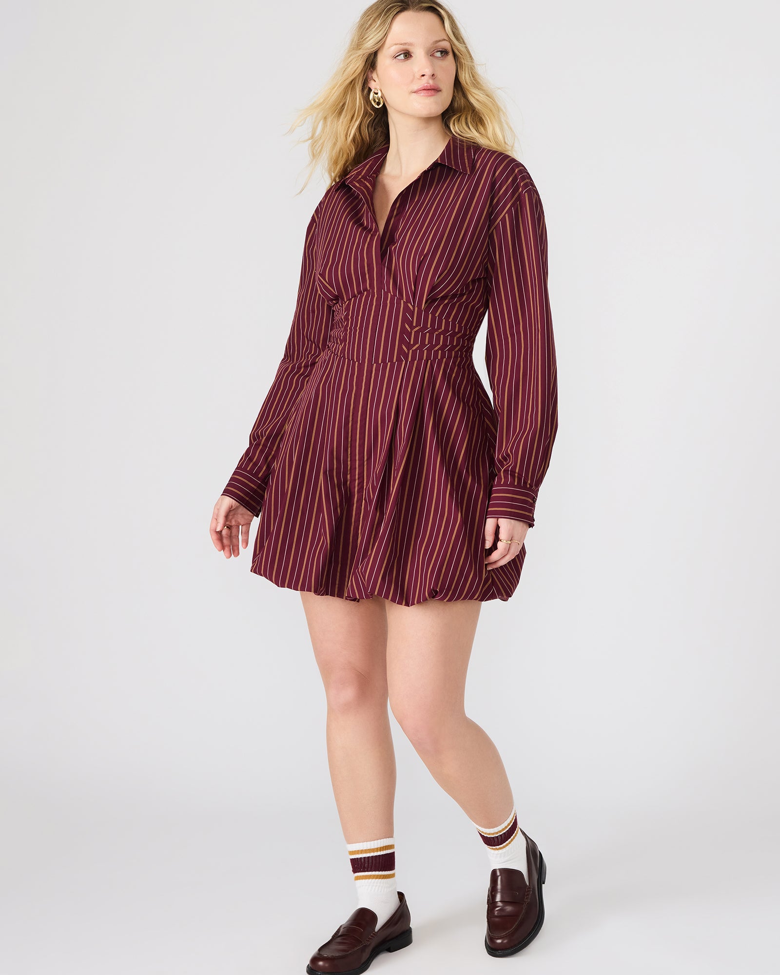Side angle of the button-up mini dress highlighting its bubble skirt.
