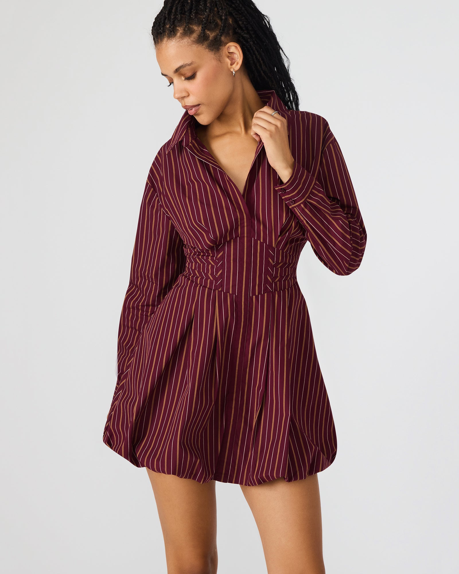 Side angle of the button-up mini dress highlighting its bubble skirt.