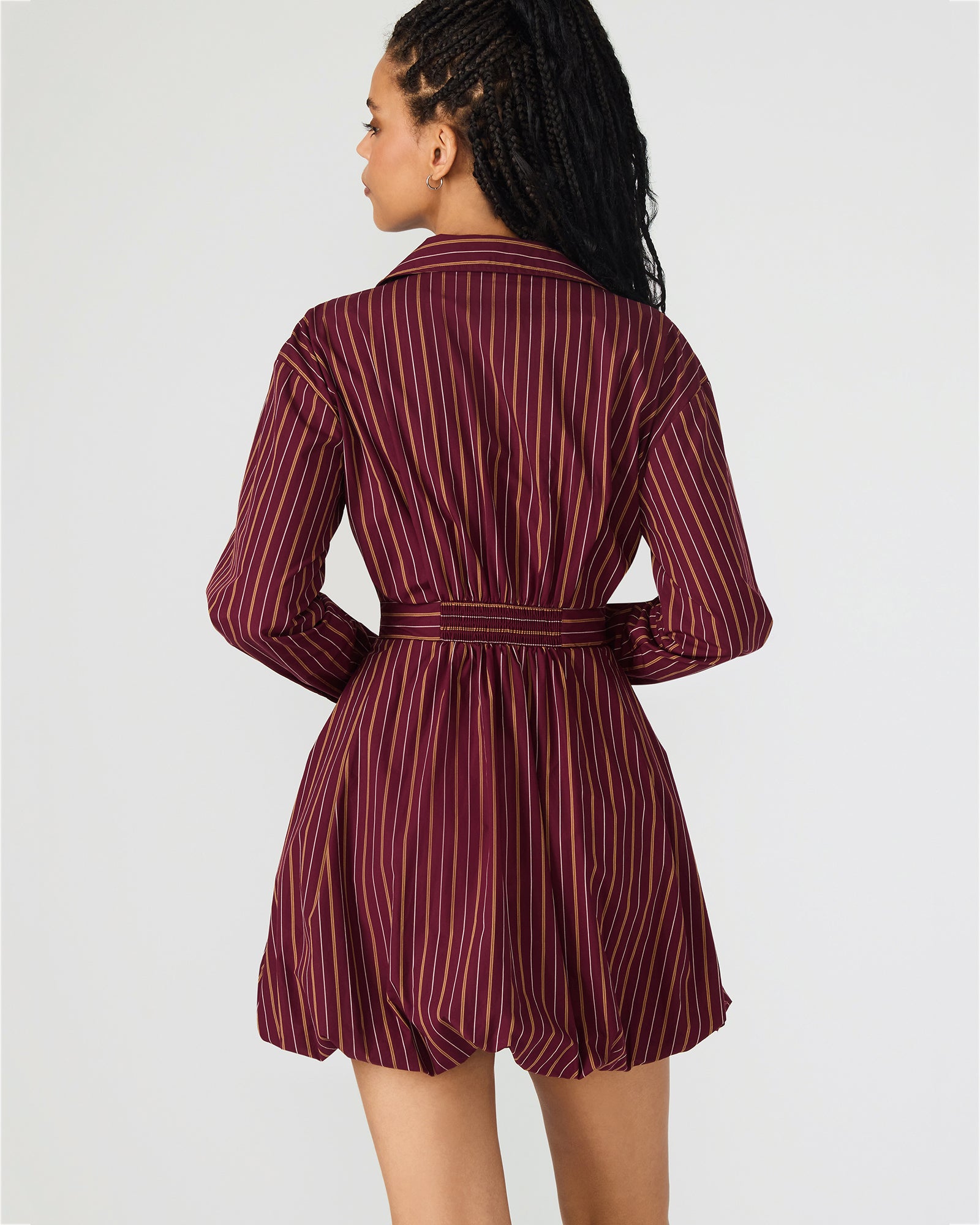 Front view of the long sleeve black mini dress in wine color.