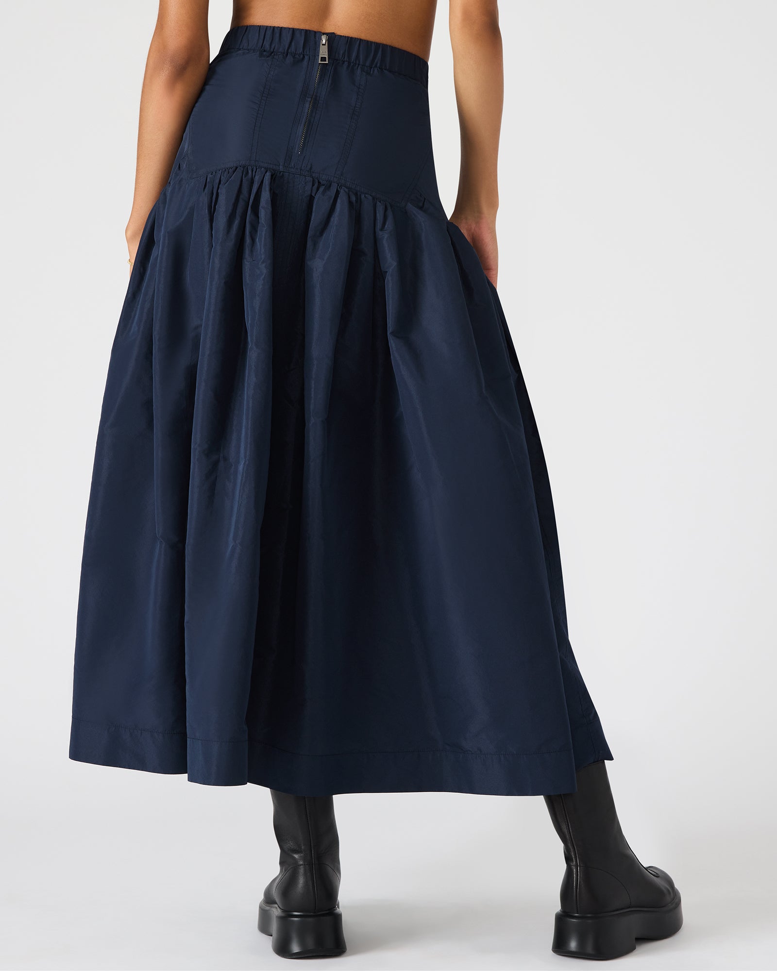 Elegant skirt paired with white blouse for evening wear