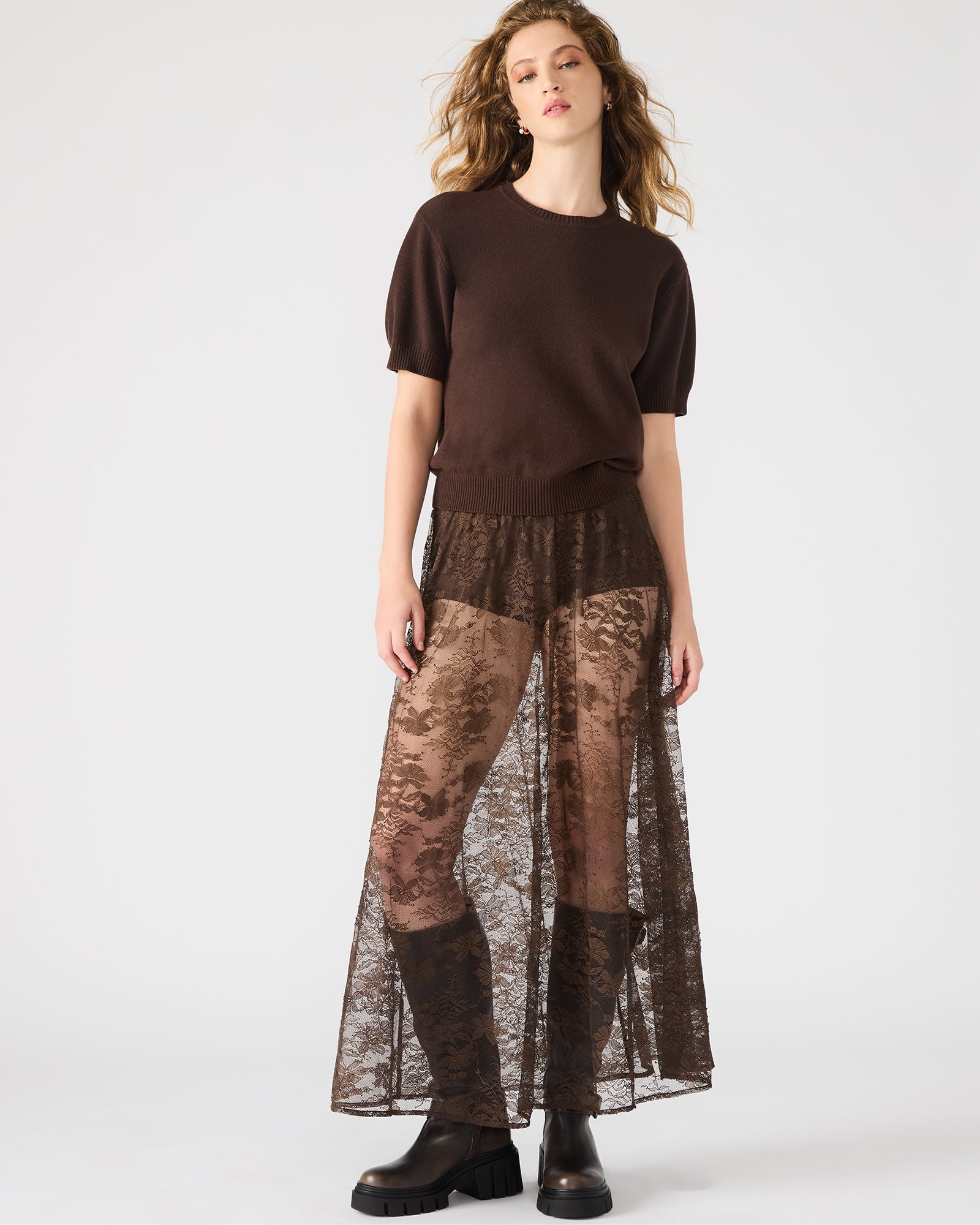 Front view of the dark espresso maxi lace skirt showcasing its intricate lace patterns.