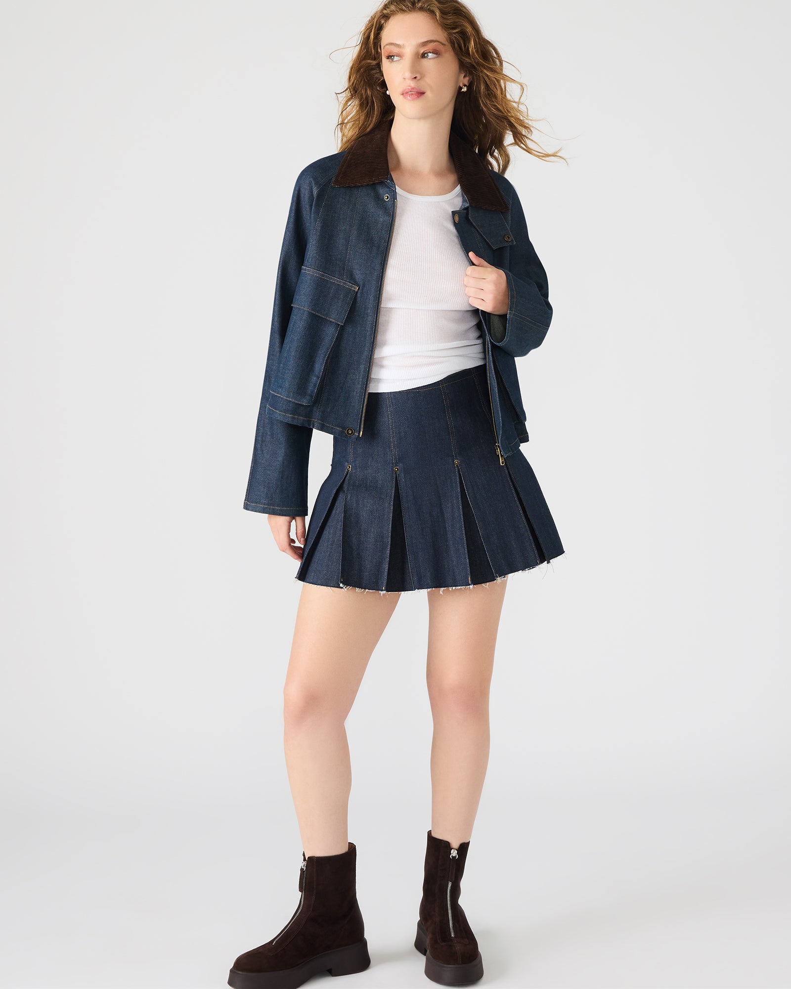 Model wearing the Joan denim mini skirt paired with a casual top for everyday styling