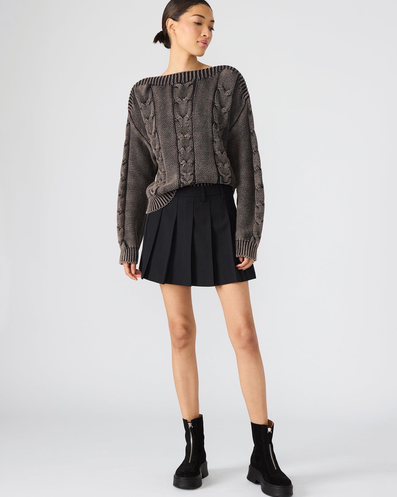 Black pleated mini skirt worn with a casual tee, perfect for city outings