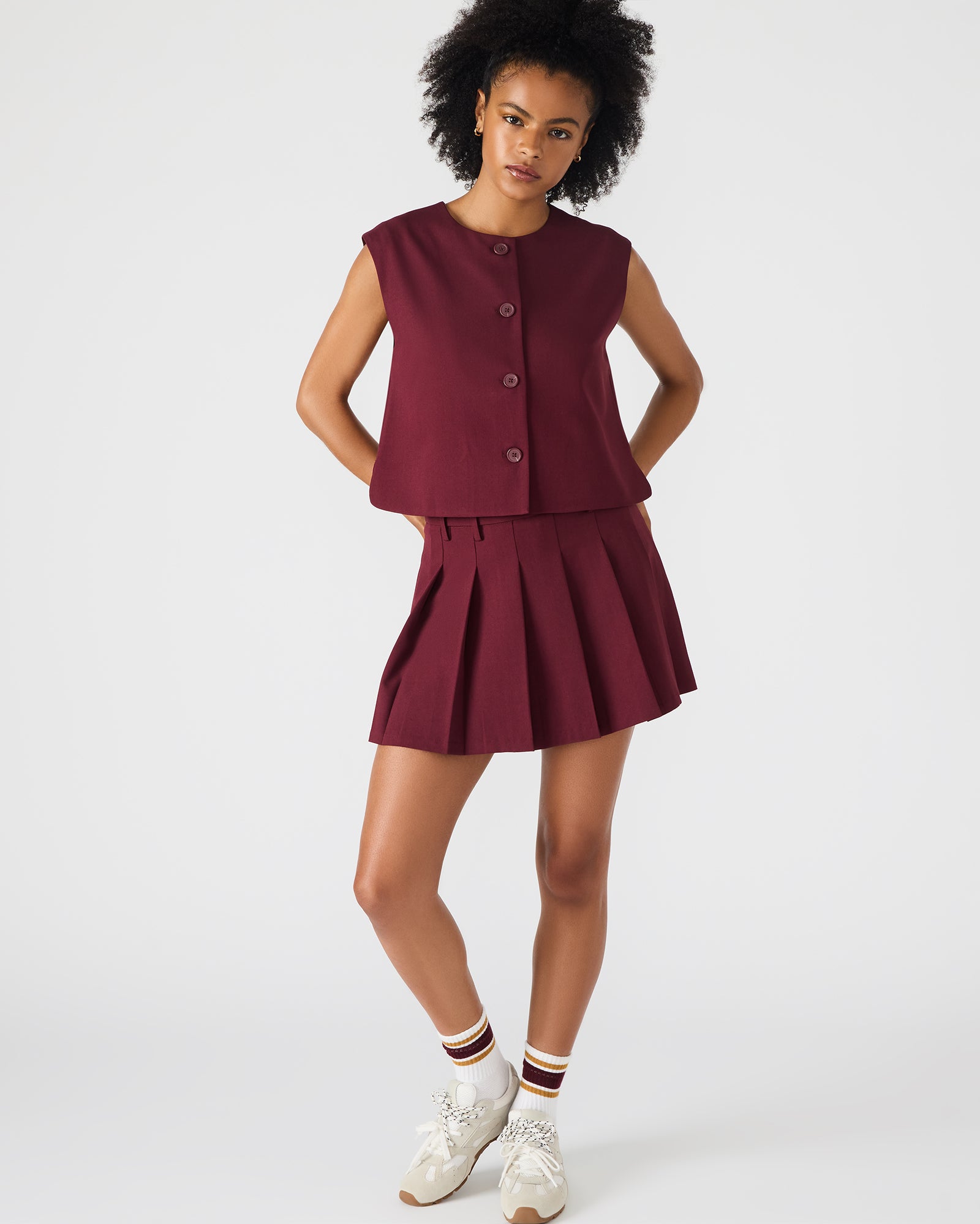 Side view showing stretch fit of Margo skirt paired with a tucked-in blouse