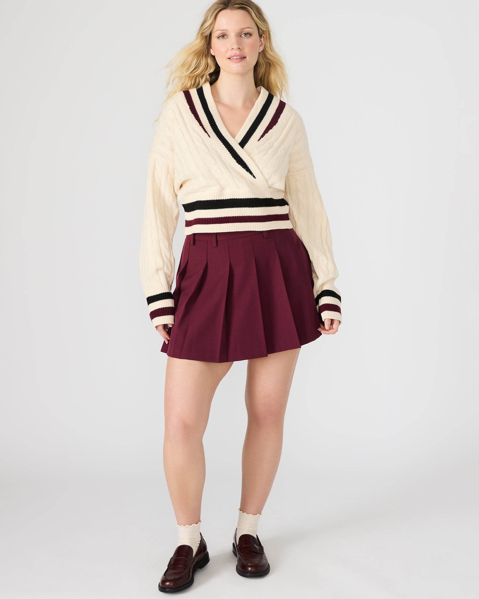 Close-up of pleated detail on wine mini skirt with natural lighting