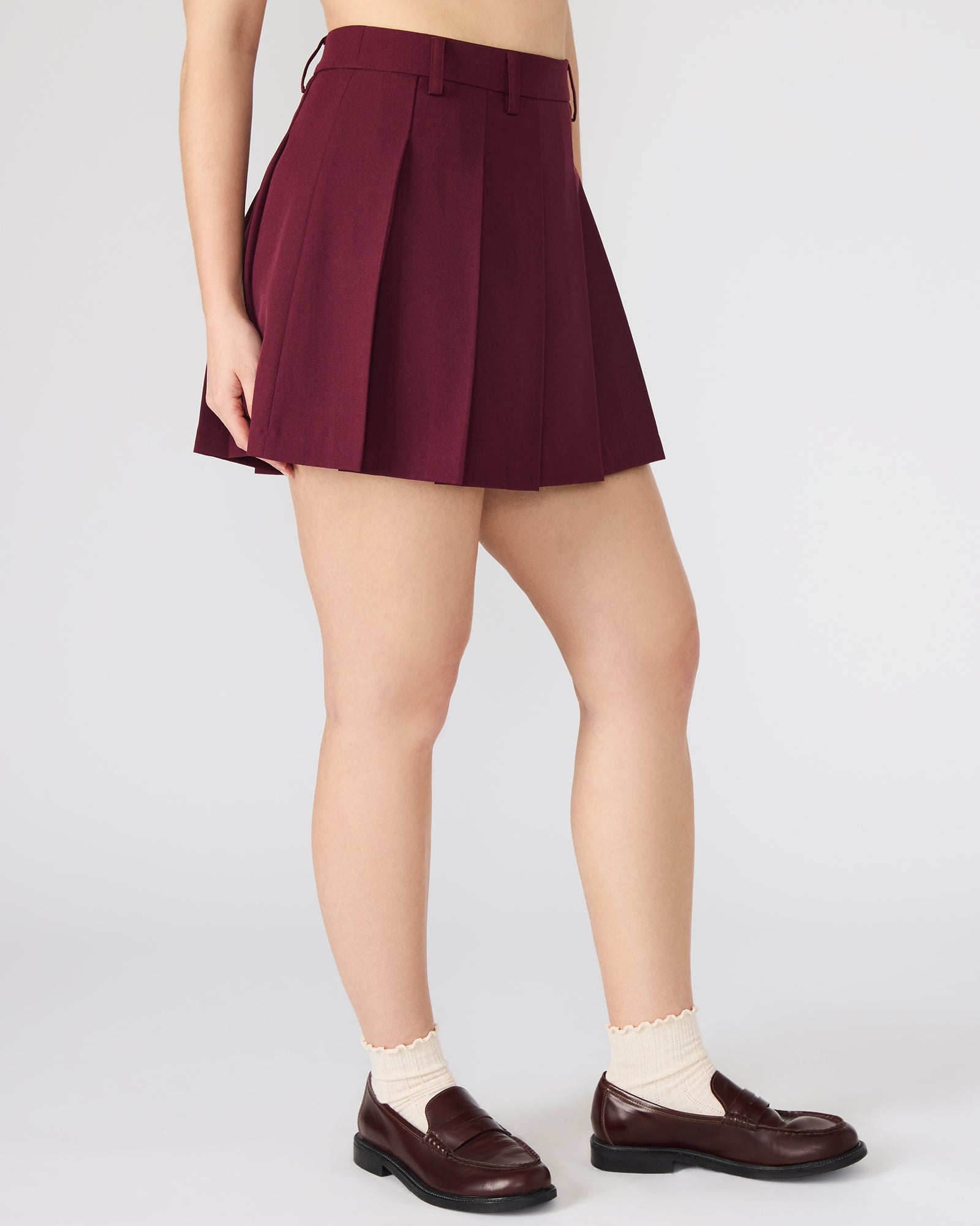 Side view showing stretch fit of Margo skirt paired with a tucked-in blouse