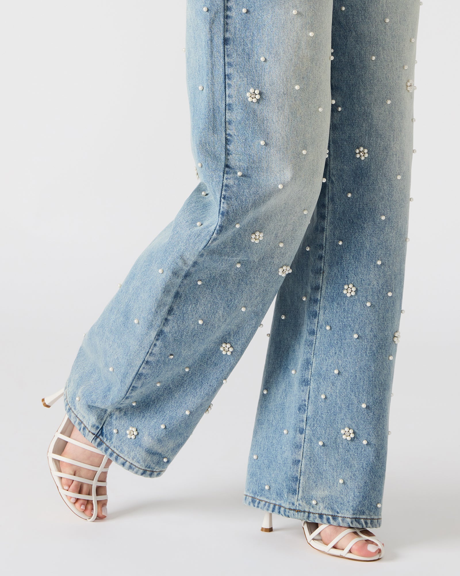 Back view of denim cargo pants showing pocket details and wide-leg cut