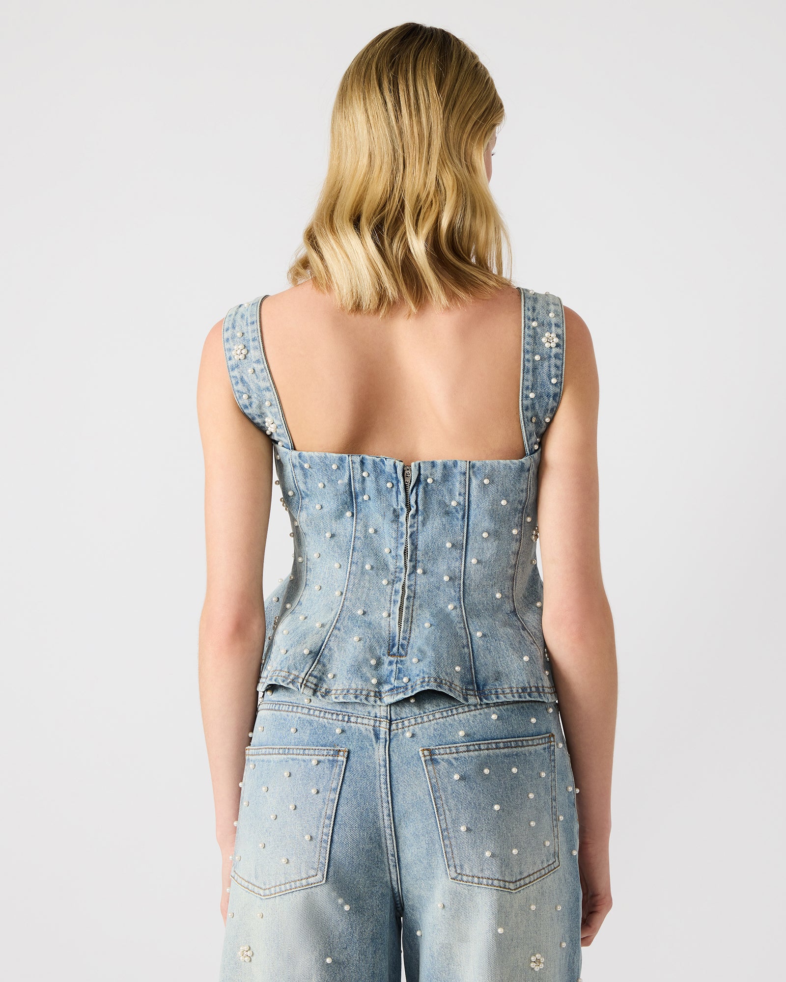 Side angle of the denim tank top women’s fit styled with matching set