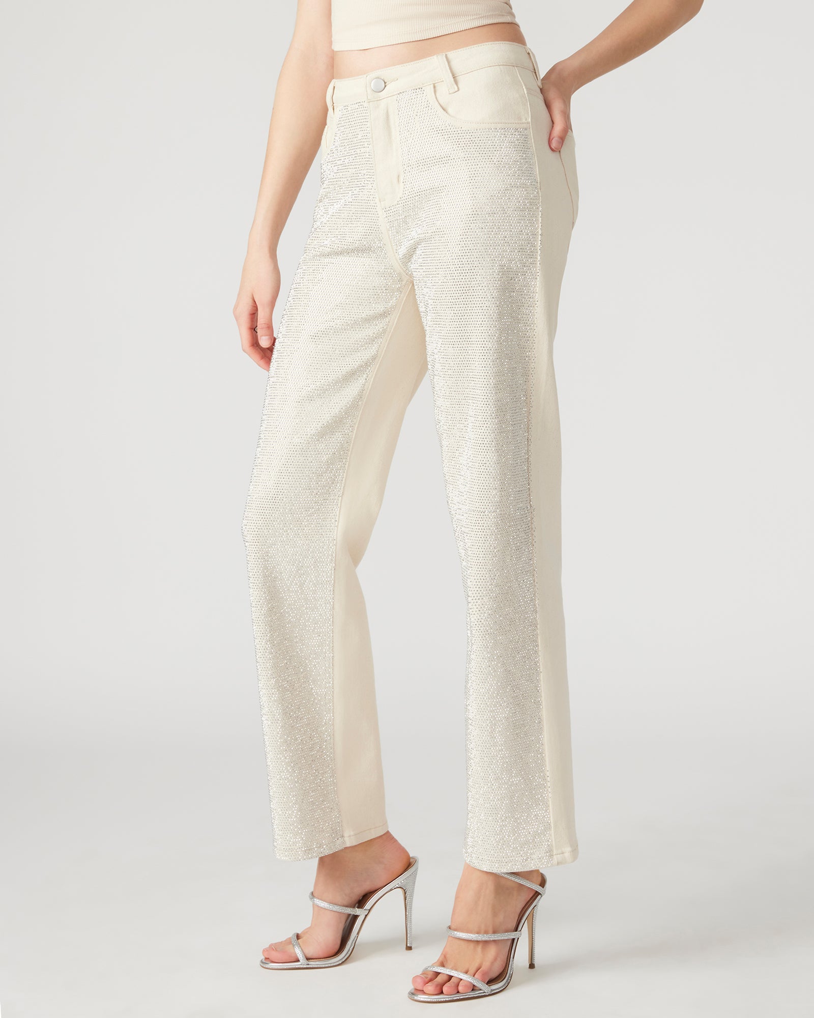 Detail shot of embellished jeans showcasing rhinestone accents.