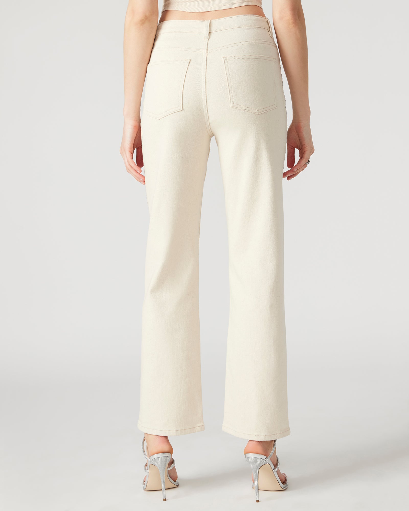 Jesse white straight leg jeans with rhinestones, styled for a night out.