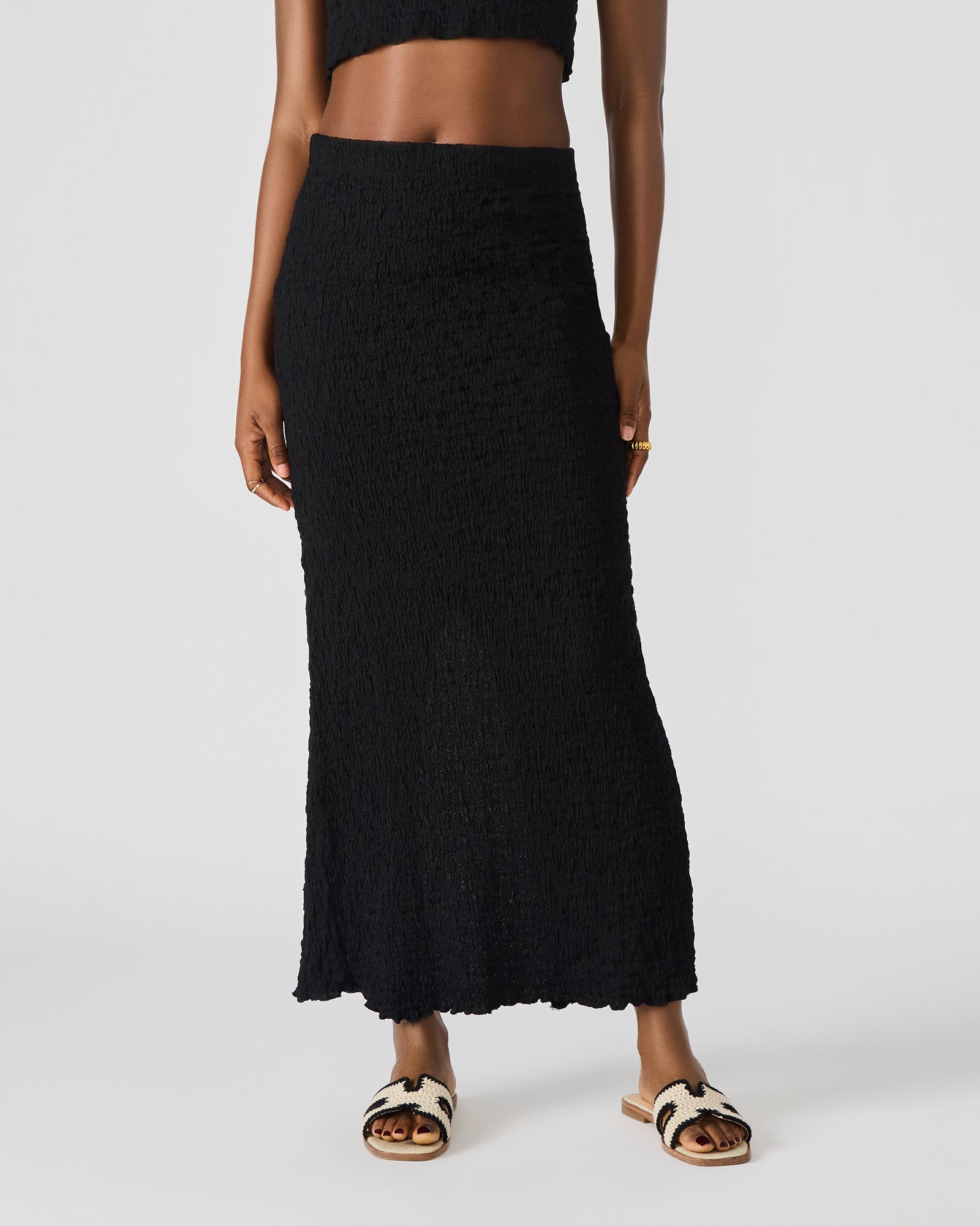 Close-up of the textured fabric and stitching of the matching skirt set.