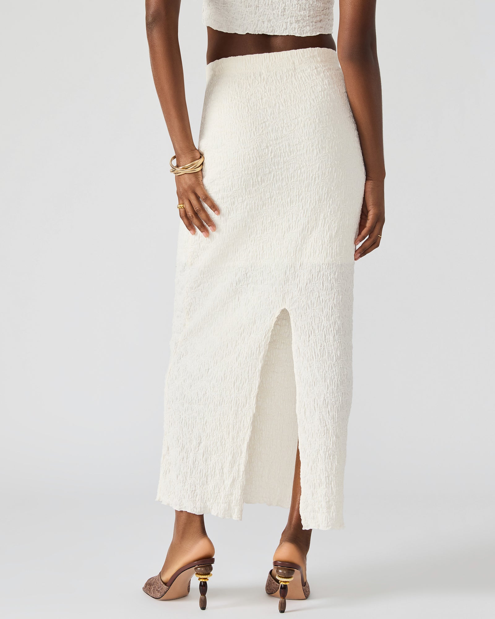 Front view of cream two-piece set with fitted maxi skirt and cropped top, styled for summer outfits.