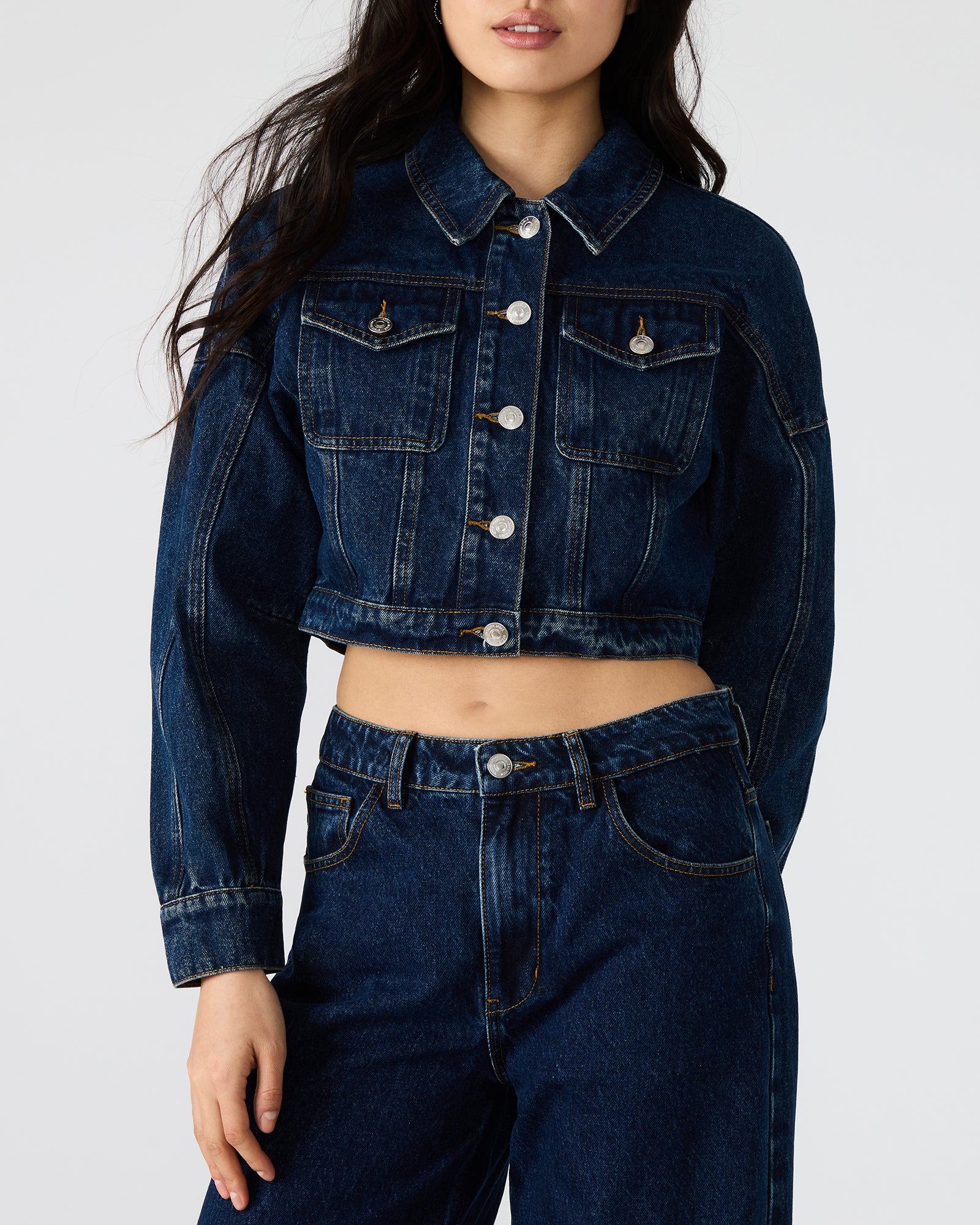 Close-up of textured denim fabric and stitching details