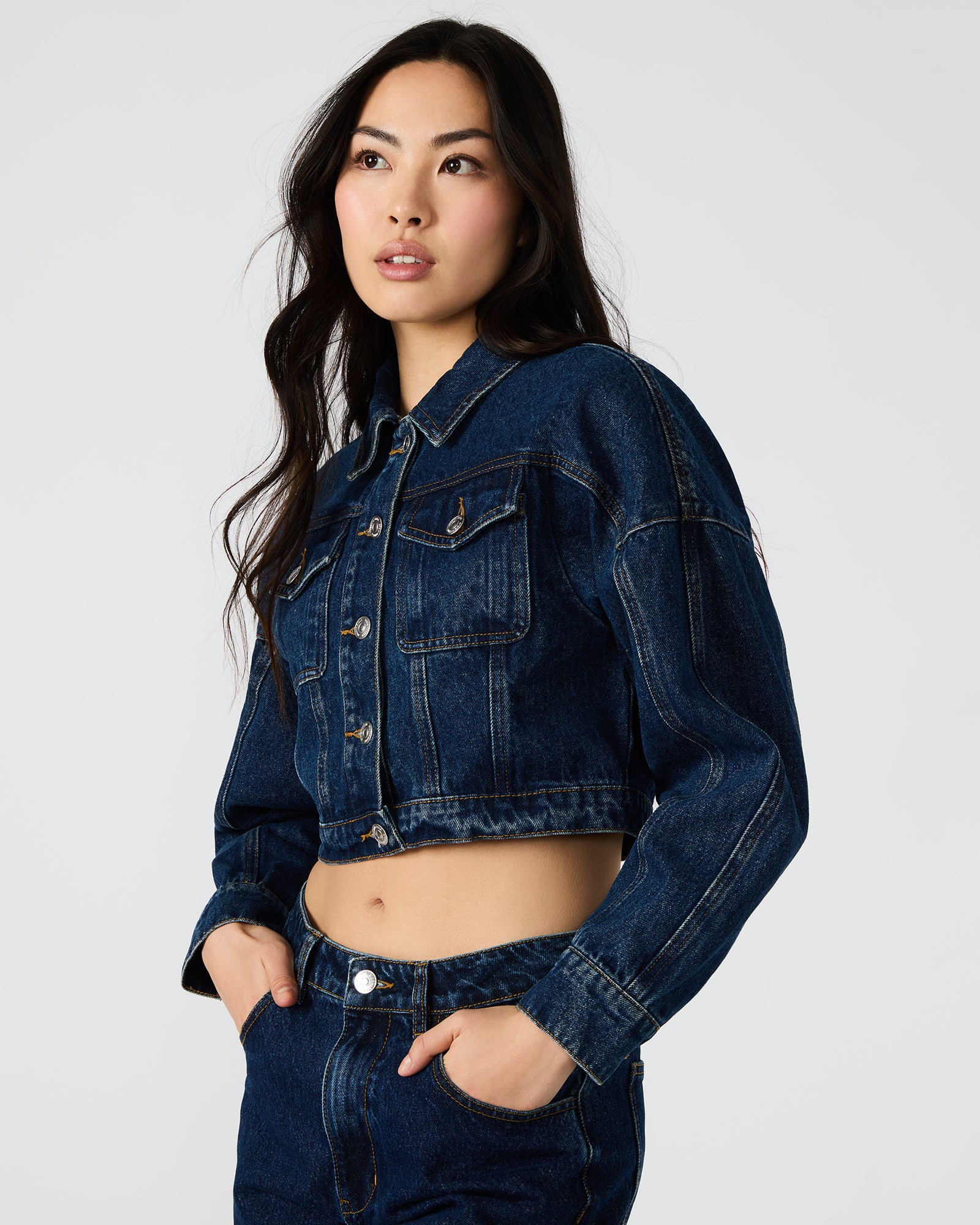 Model in oversized denim jacket layered with hoodie