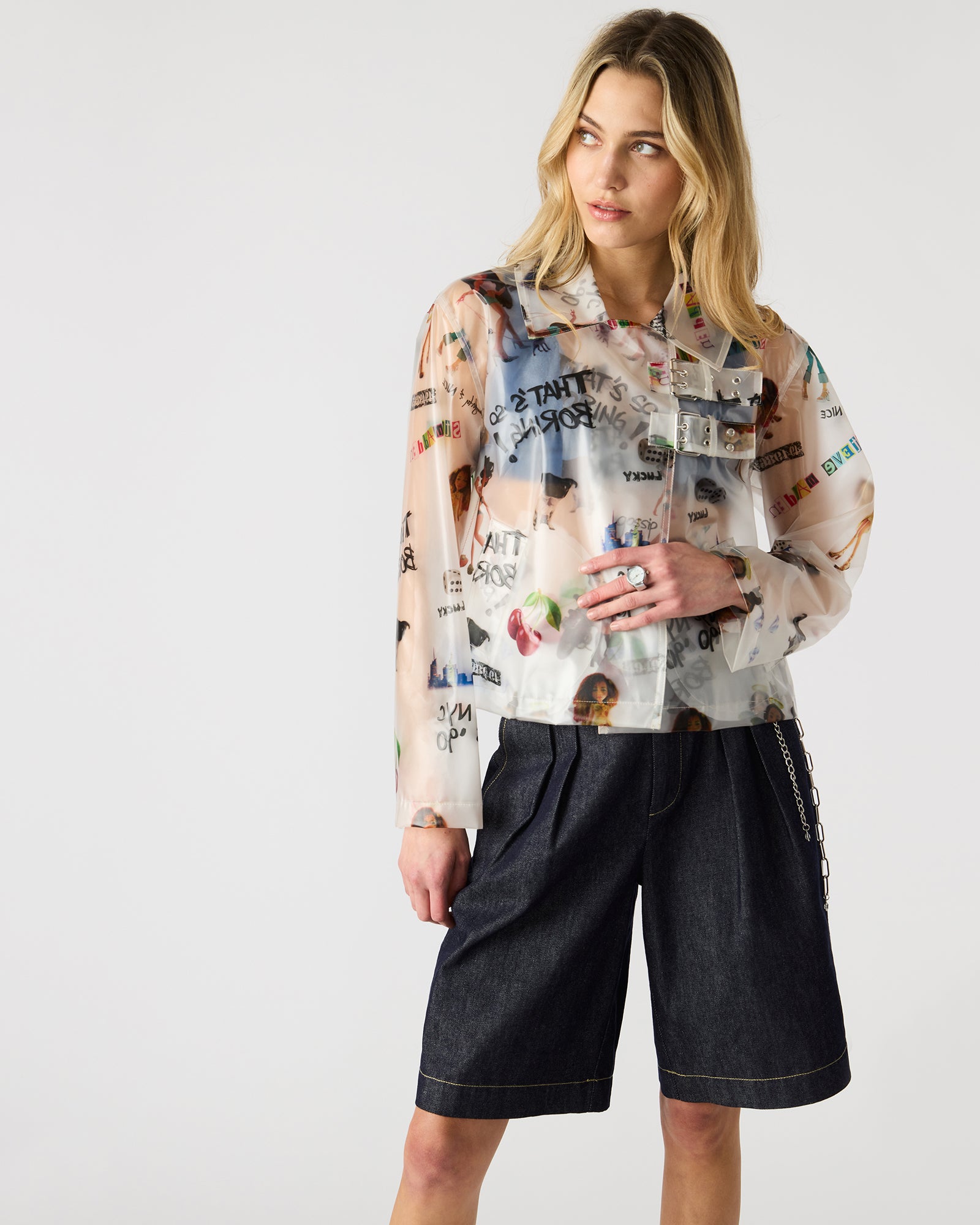 Model wearing the transparent jacket in an urban setting, highlighting its stylish look.