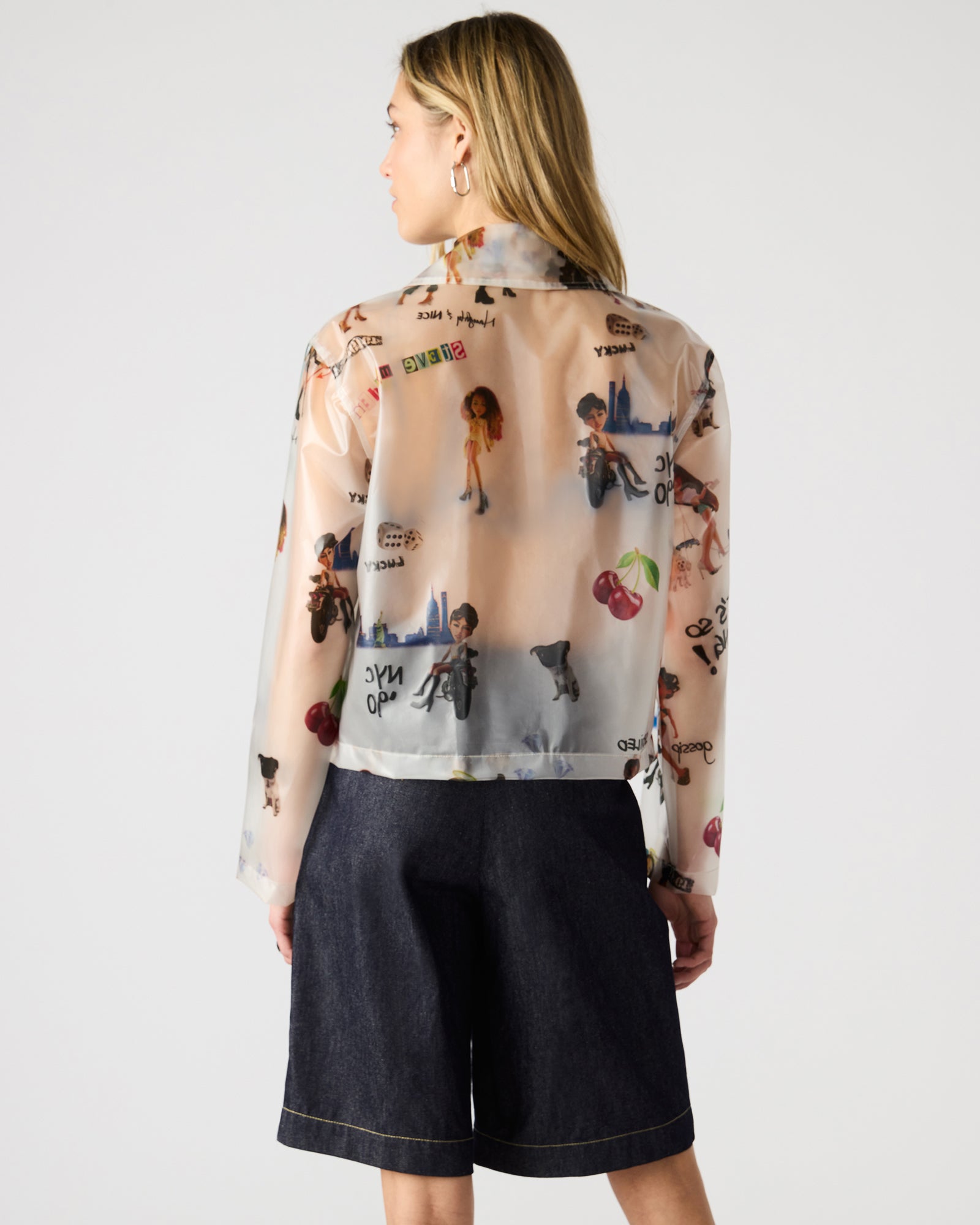 Detail of the functional front pockets on the graphic bomber jacket.