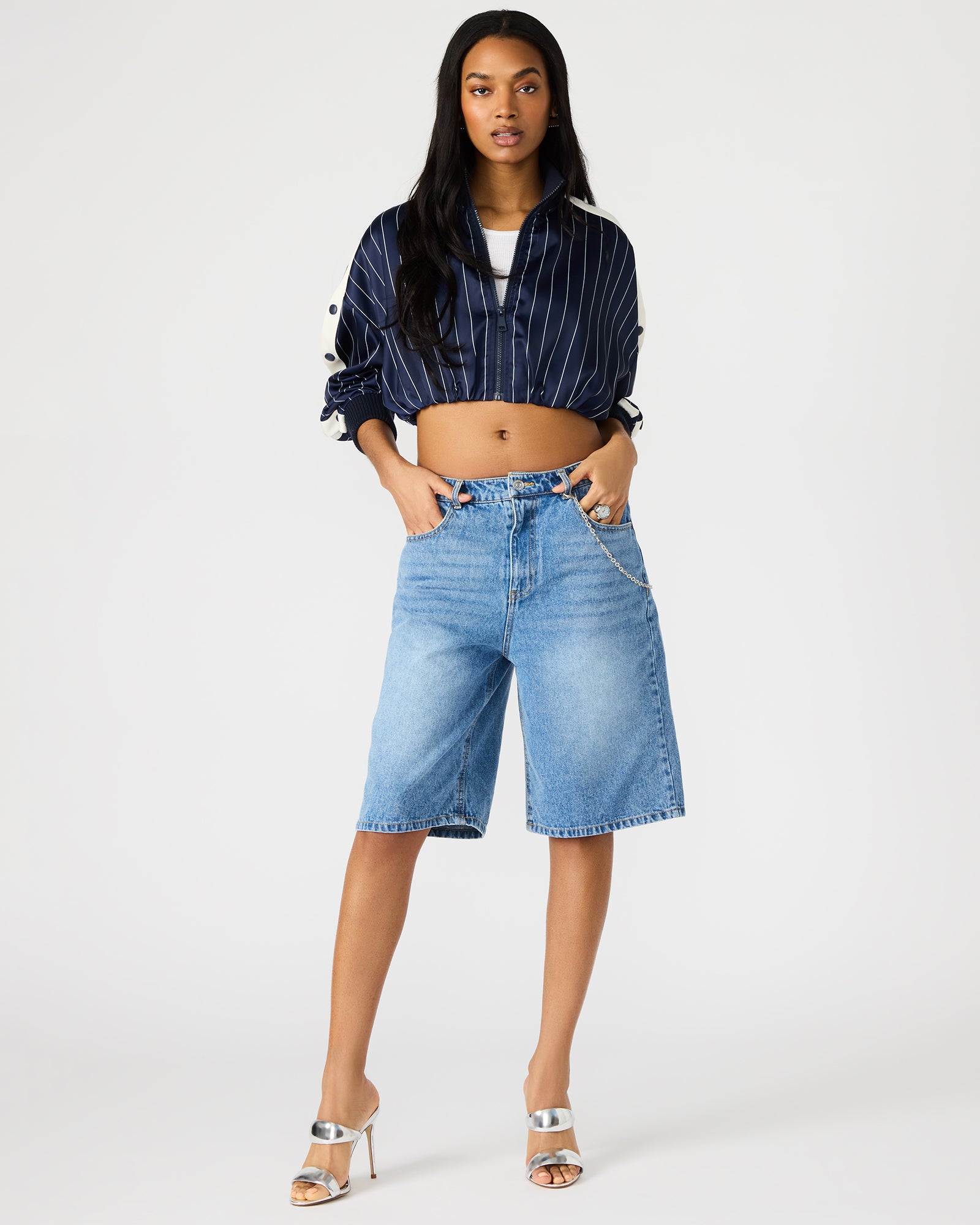 Magdalen black denim jean shorts on a model, showcasing front pockets and fit