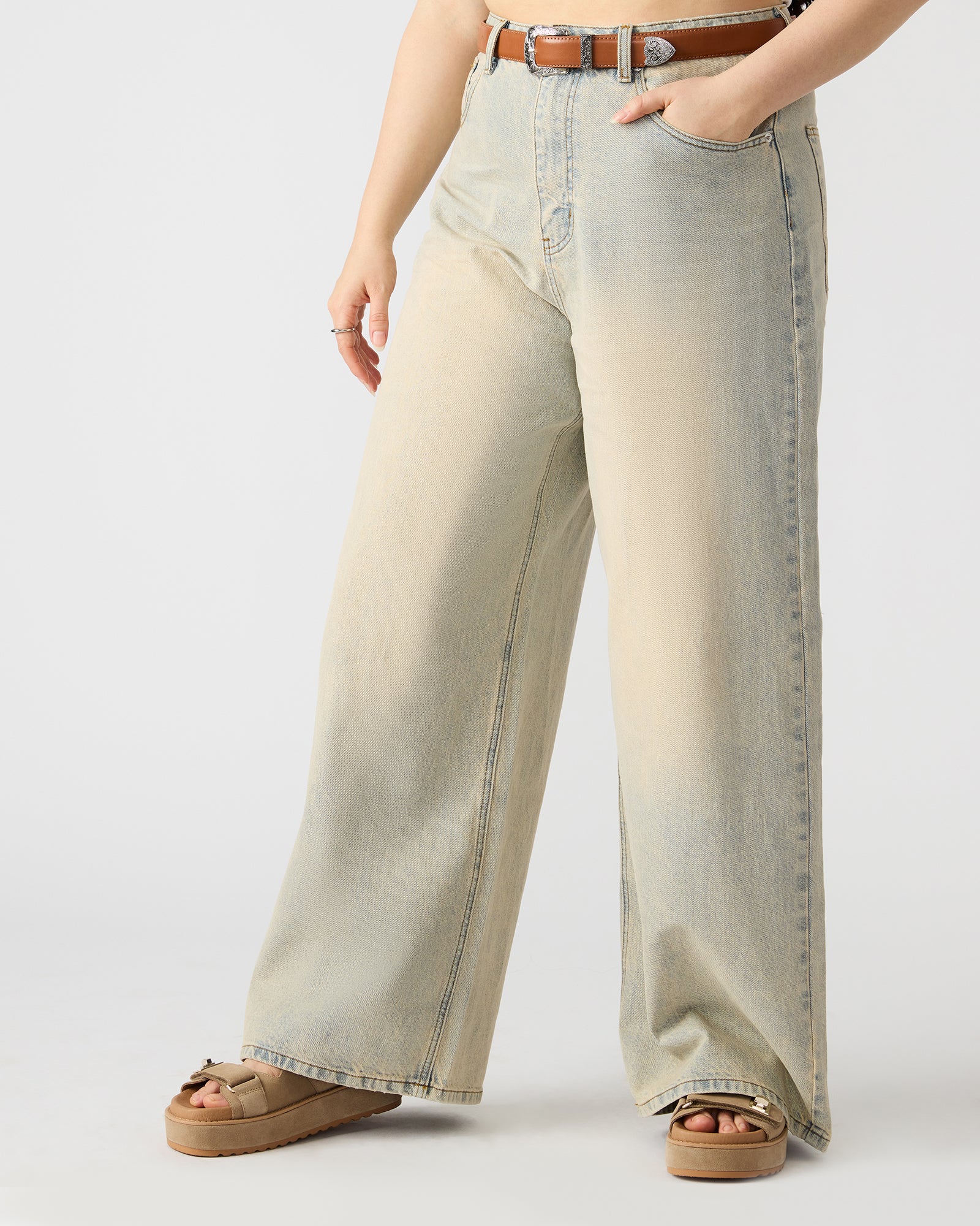 Close-up of the zipper and button detail on Magnus denim jeans.