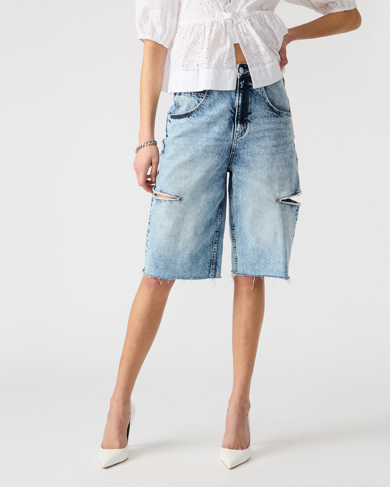 Close-up of LANGE barrel denim shorts highlighting functional pockets.