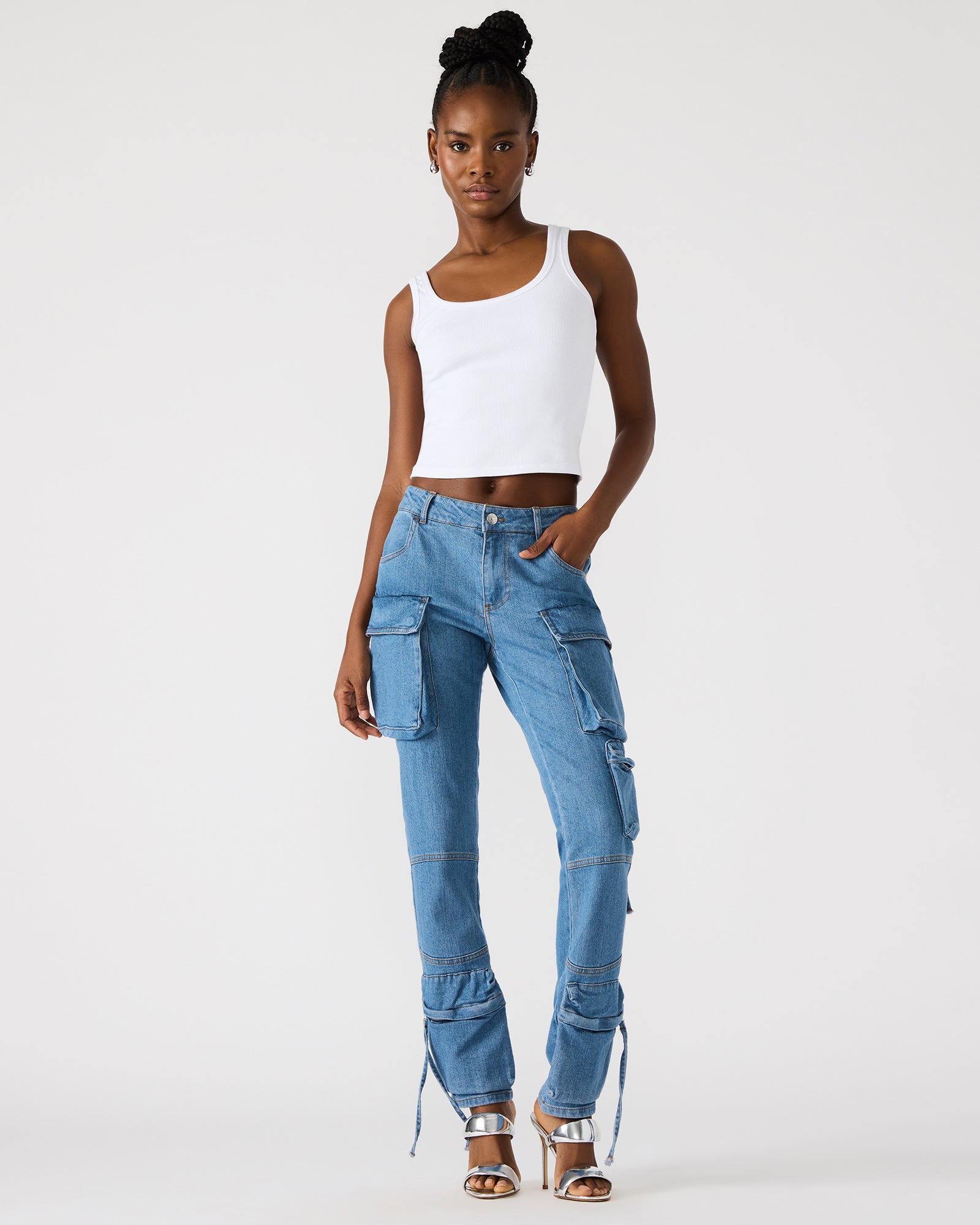 Black cargo pants displayed on a model in a city setting.