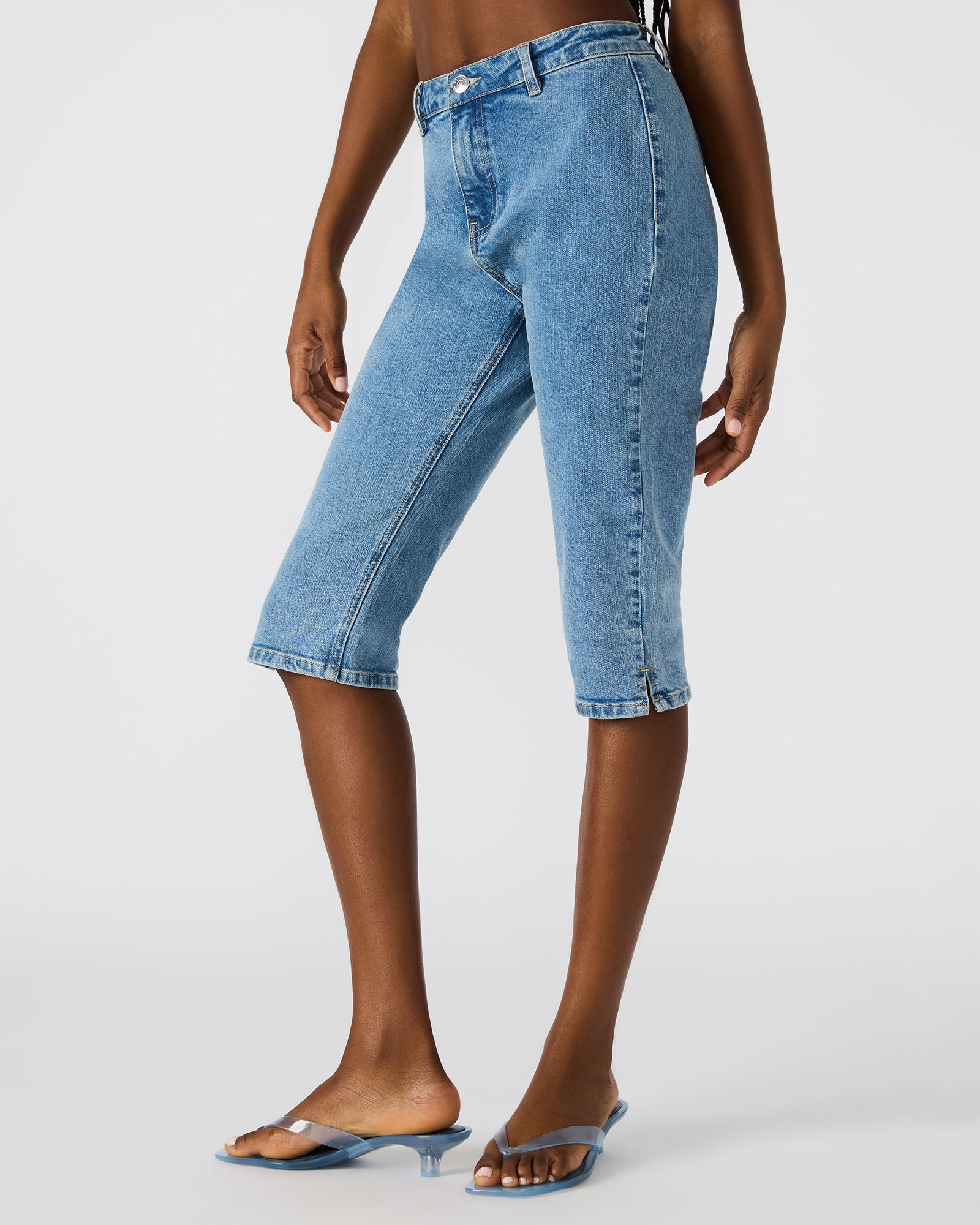 Rina Skinny Fit Denim Capri Pants paired with a stylish top for a night out.