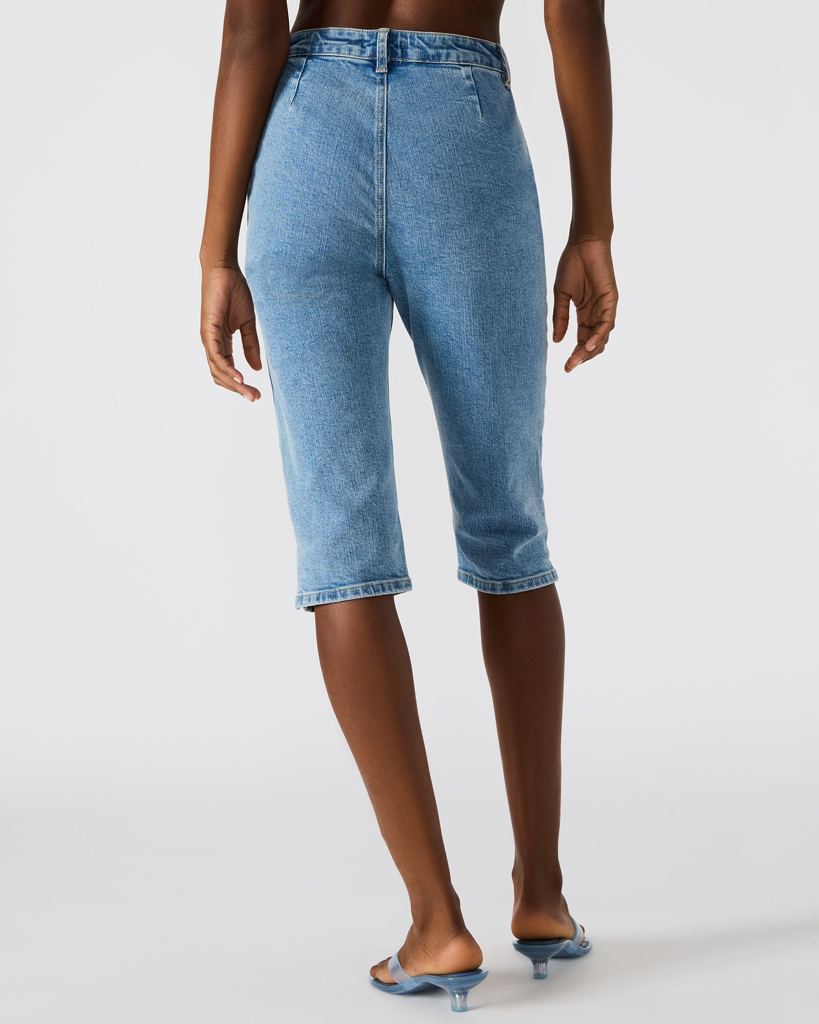 Rina Skinny Fit Denim Capri Pants displayed on a model in a casual setting.