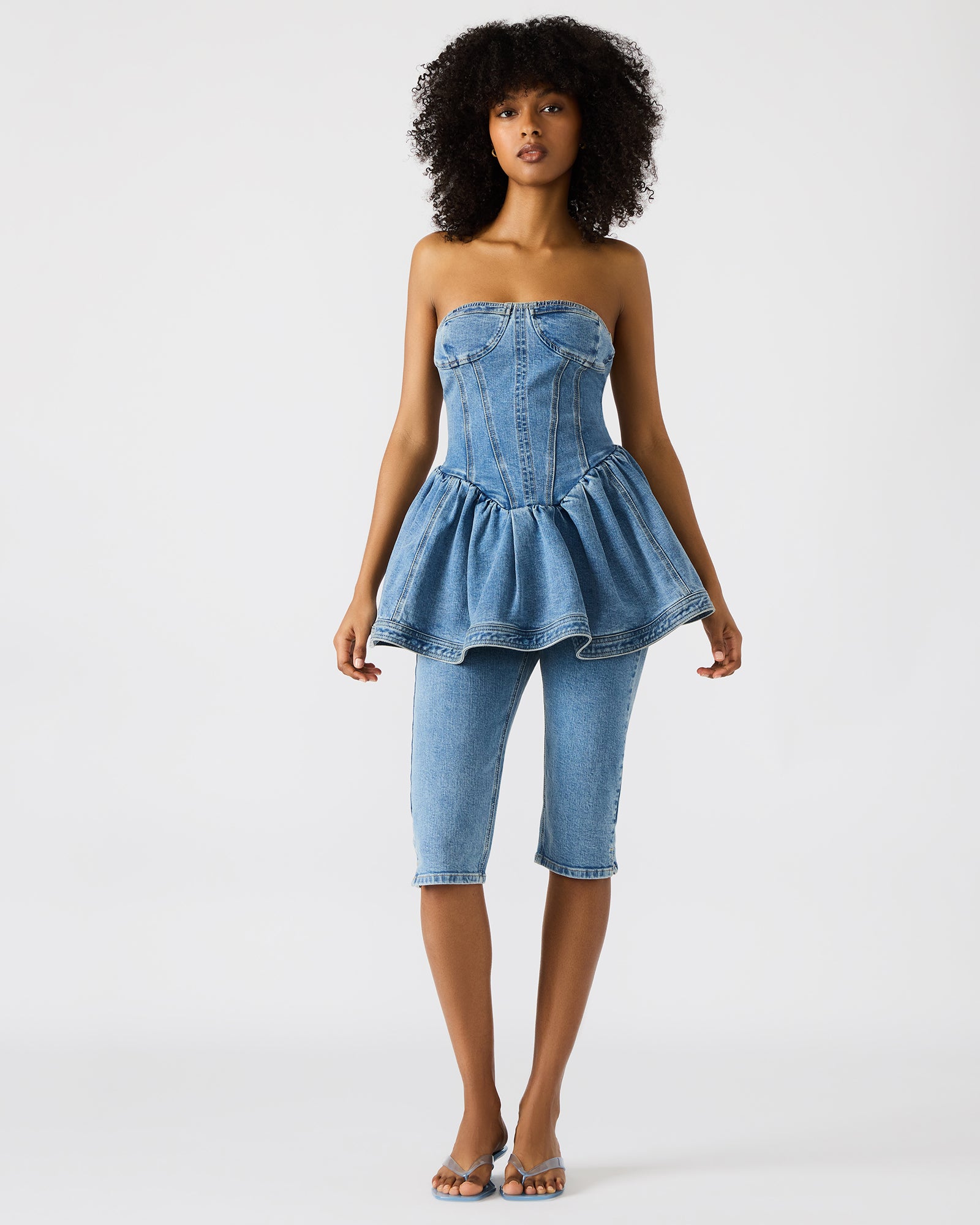 Front view of the chic strapless peplum denim top, perfect for casual wear.