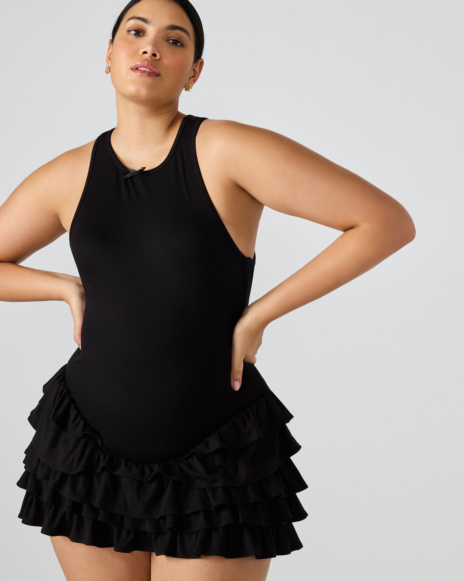 Side view of black dress with ruffled skirt worn outdoors