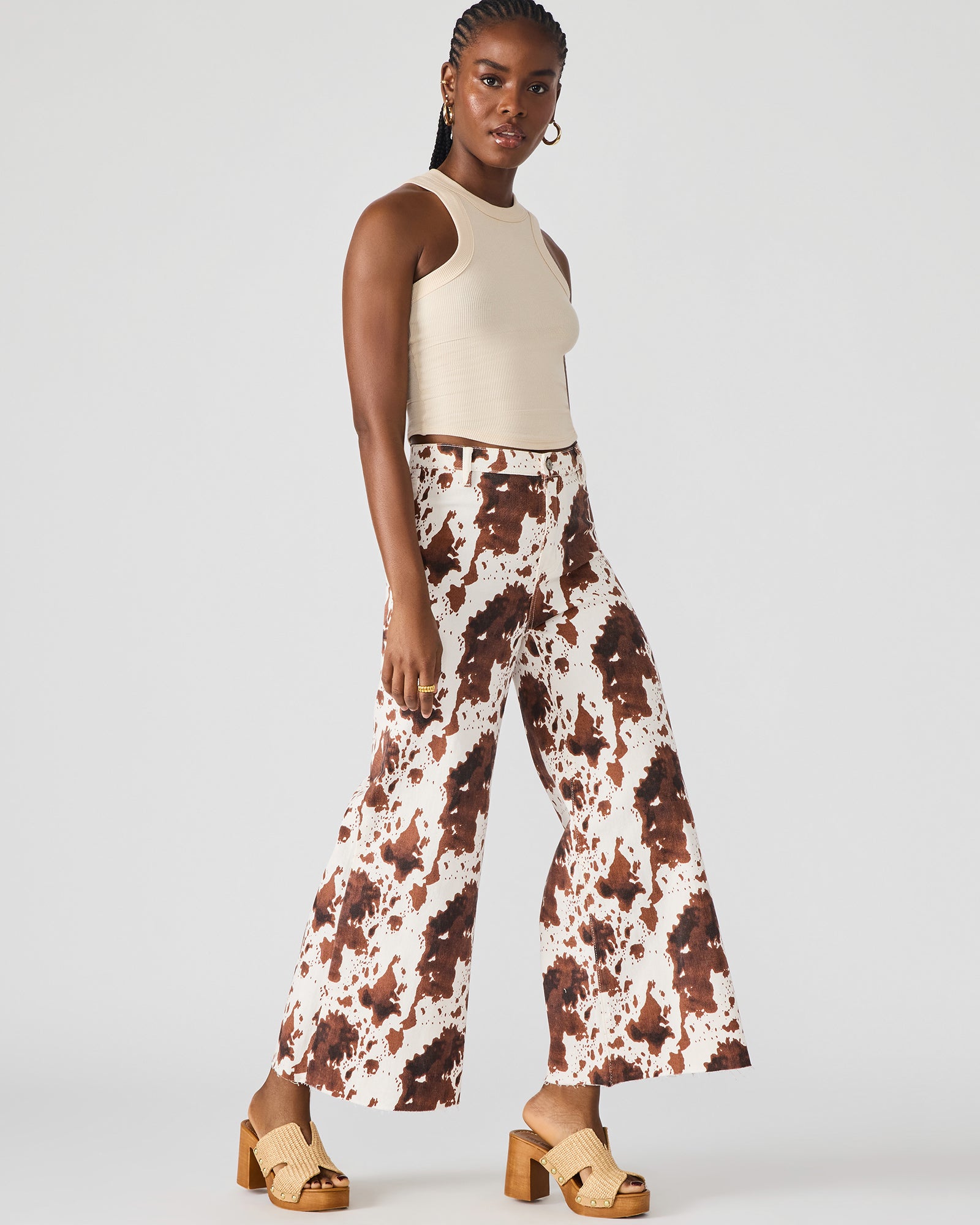 Front view of Harli cow print wide-leg jeans on a model.