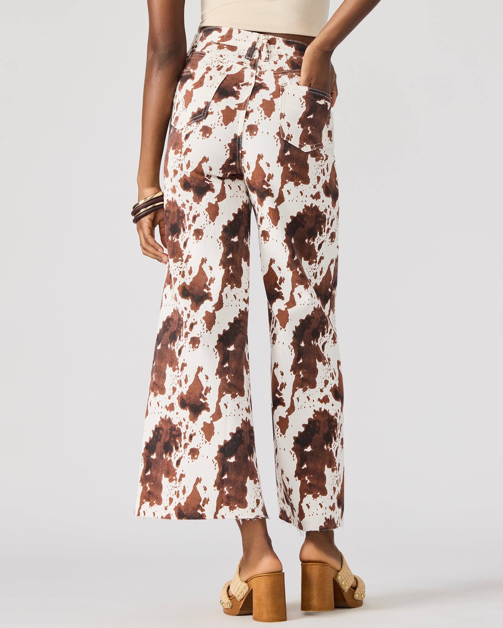 Front view of Harli cow print wide-leg jeans on a model.