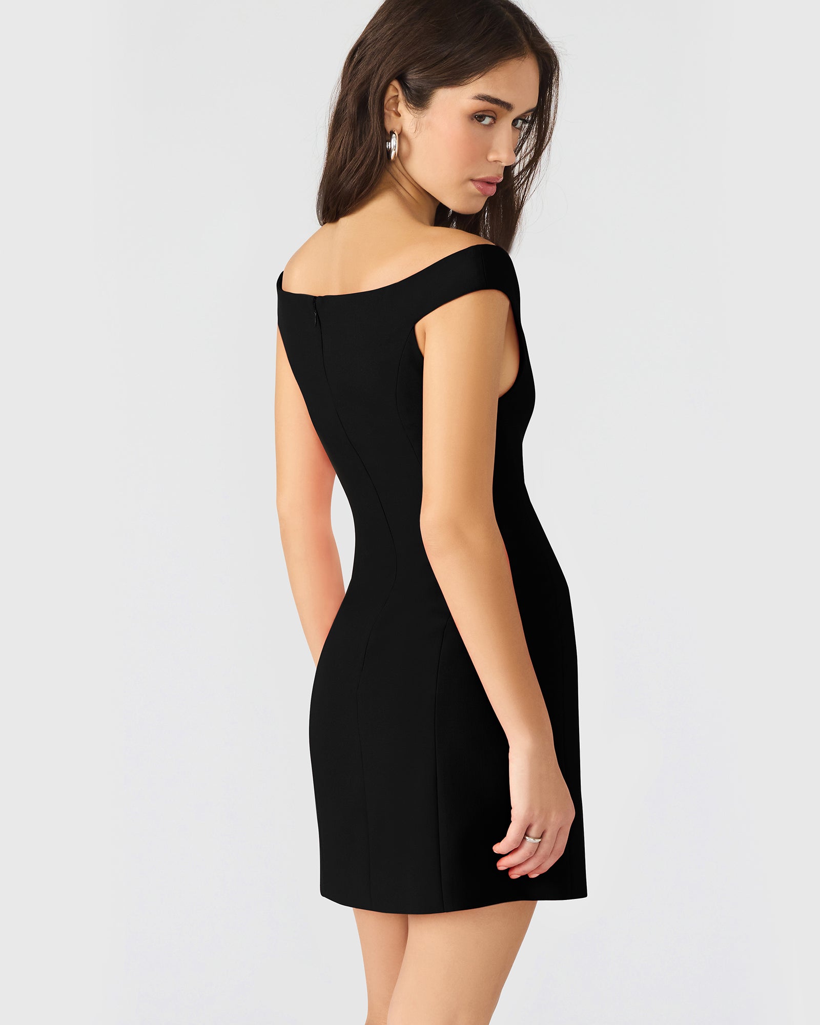 Front view of the black off-the-shoulder dress showcasing pleated design.