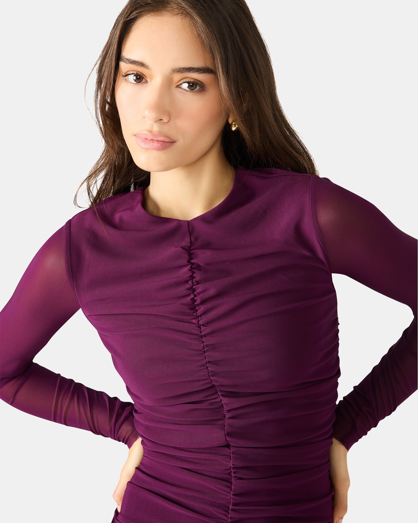 Side angle of the black long sleeve dress, highlighting the elegant silhouette.