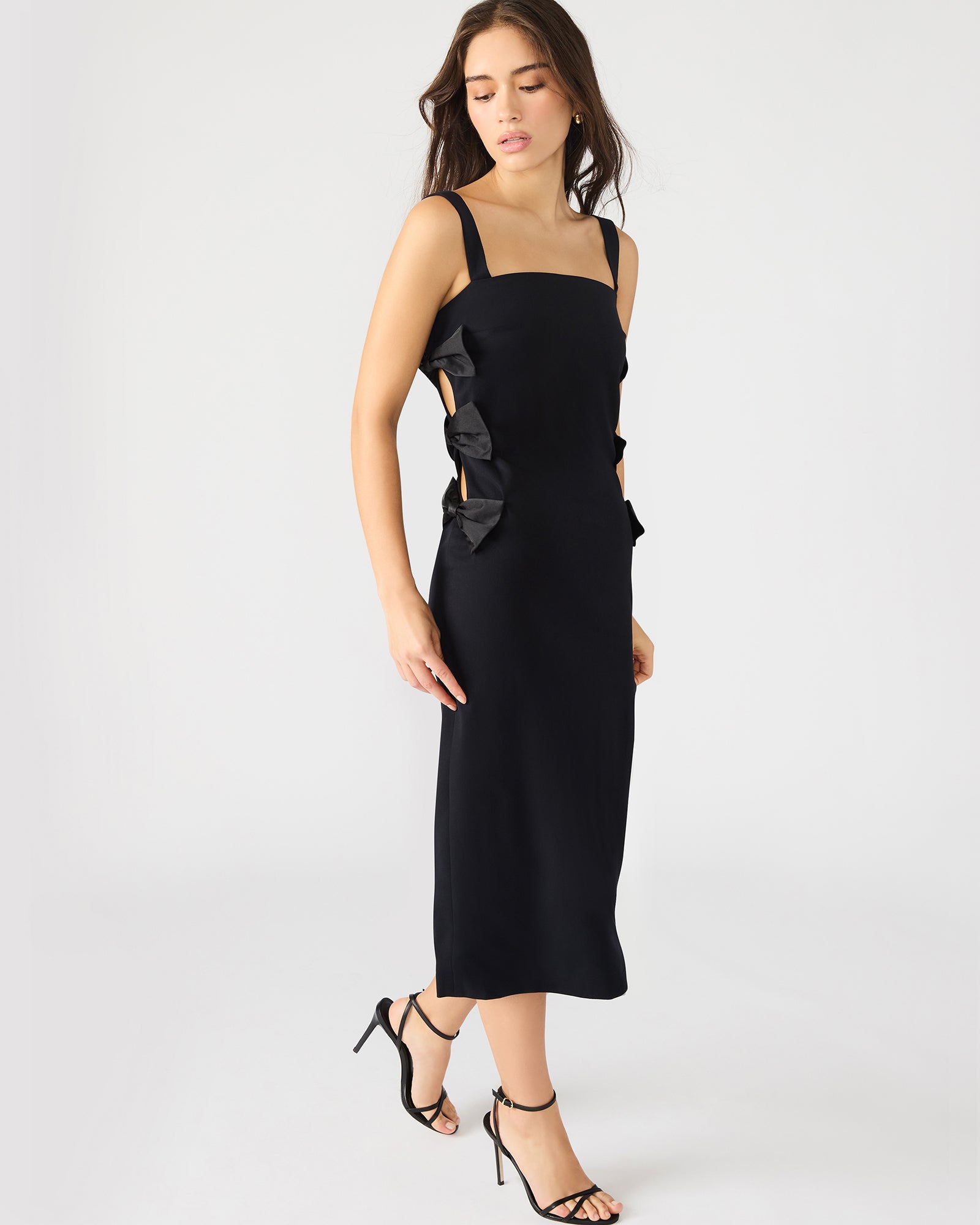 Back angle highlighting the elegant drape of this black and white midi dress