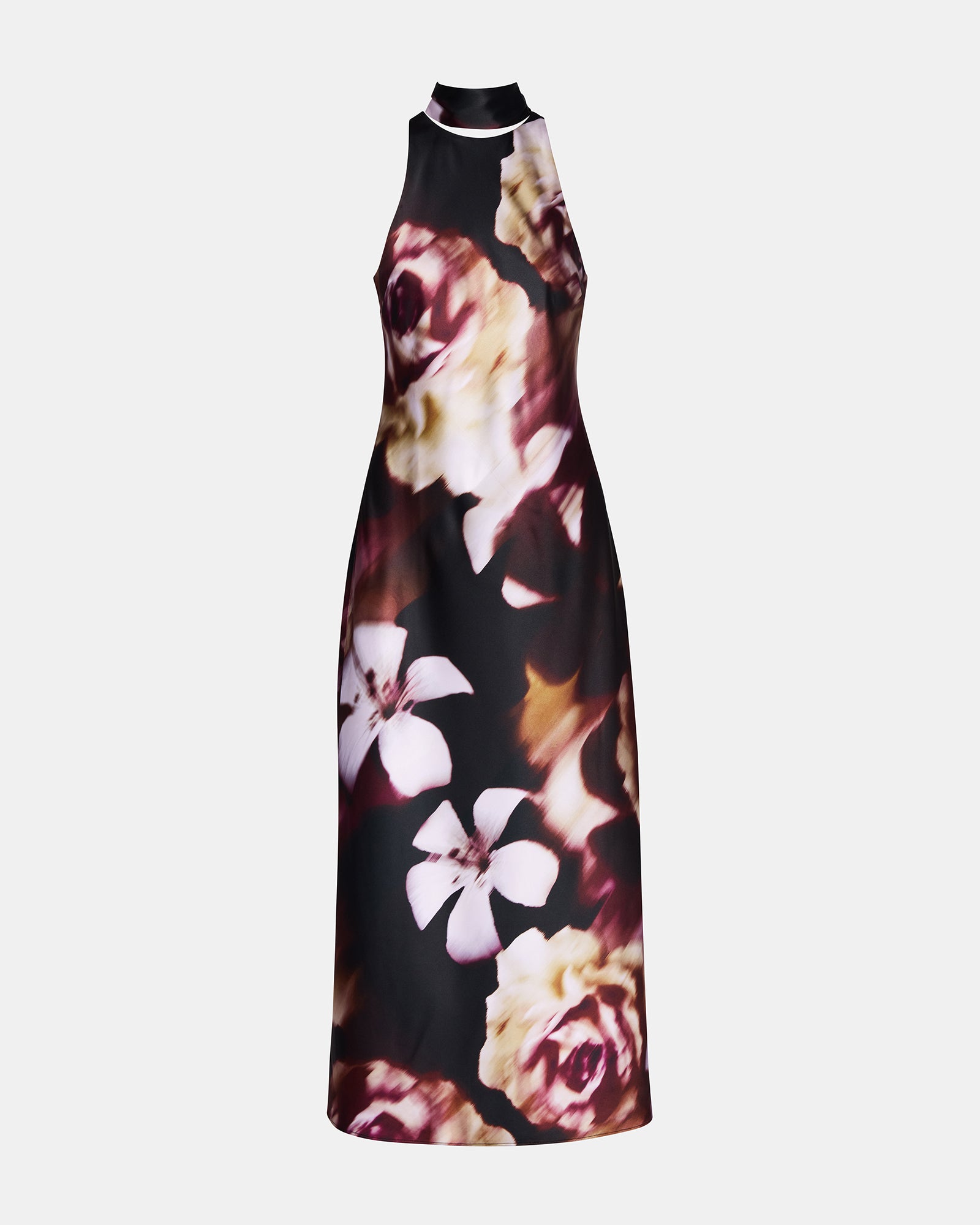Woman wearing a pink floral maxi dress in a summer garden